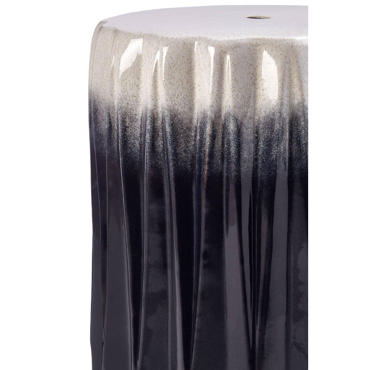 Glazed ceramic side table with black and white ombre finish and vertical ridged texture