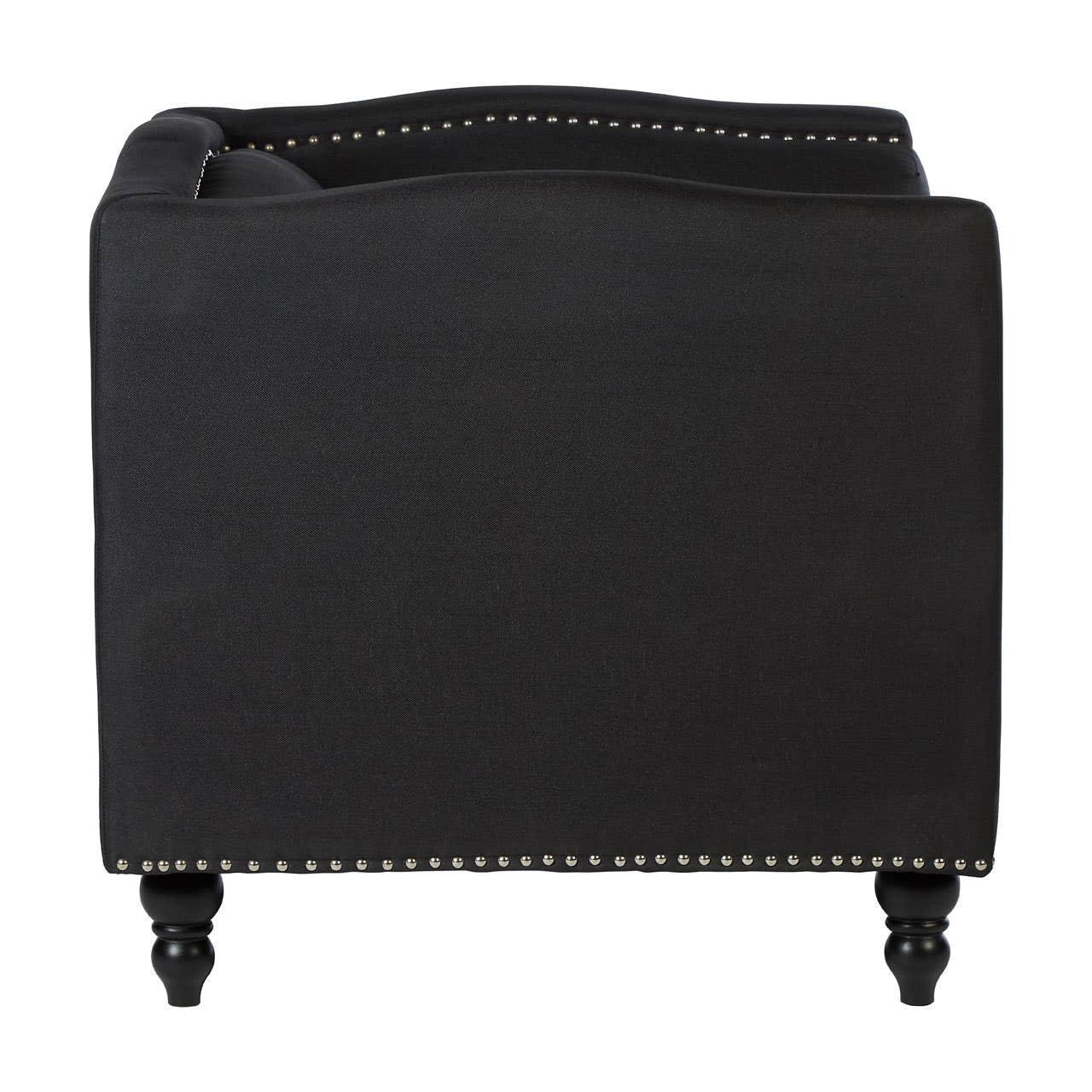 Back view of black fabric armchair with silver stud trim and turned wooden legs