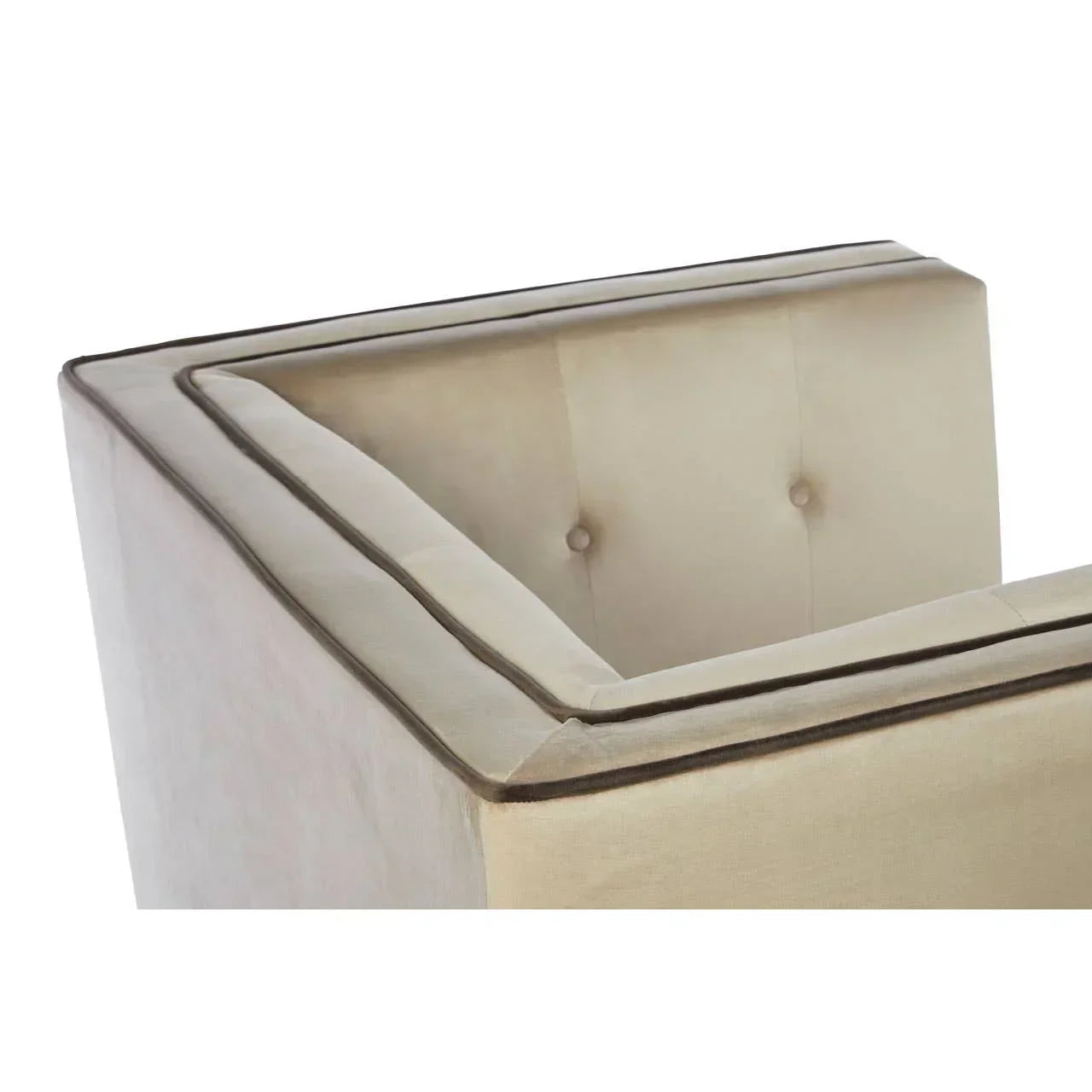 Corner view of cream velvet sofa with button-tufted back and piped trim
