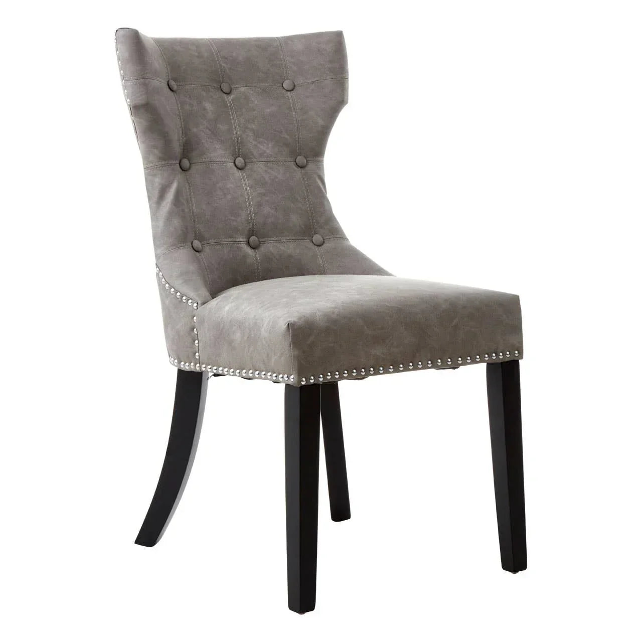 Grey fabric dining chair with button tufting and nailhead trim on black wooden legs