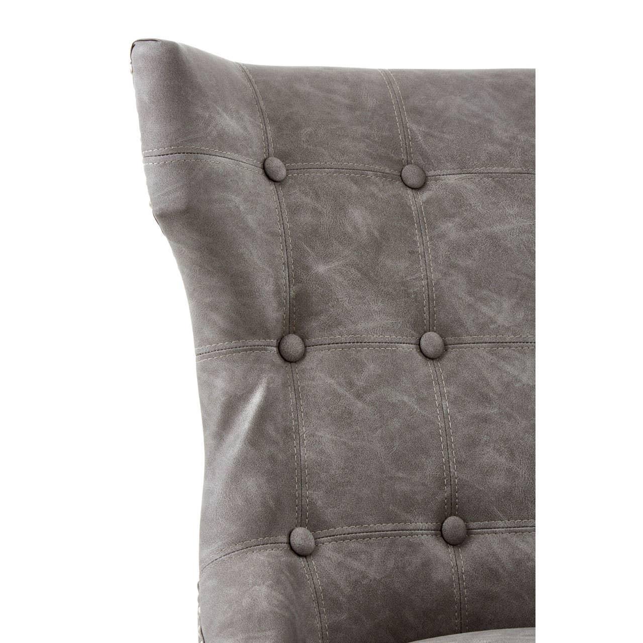 Close up of grey faux leather dining chair with button-tufted backrest detail