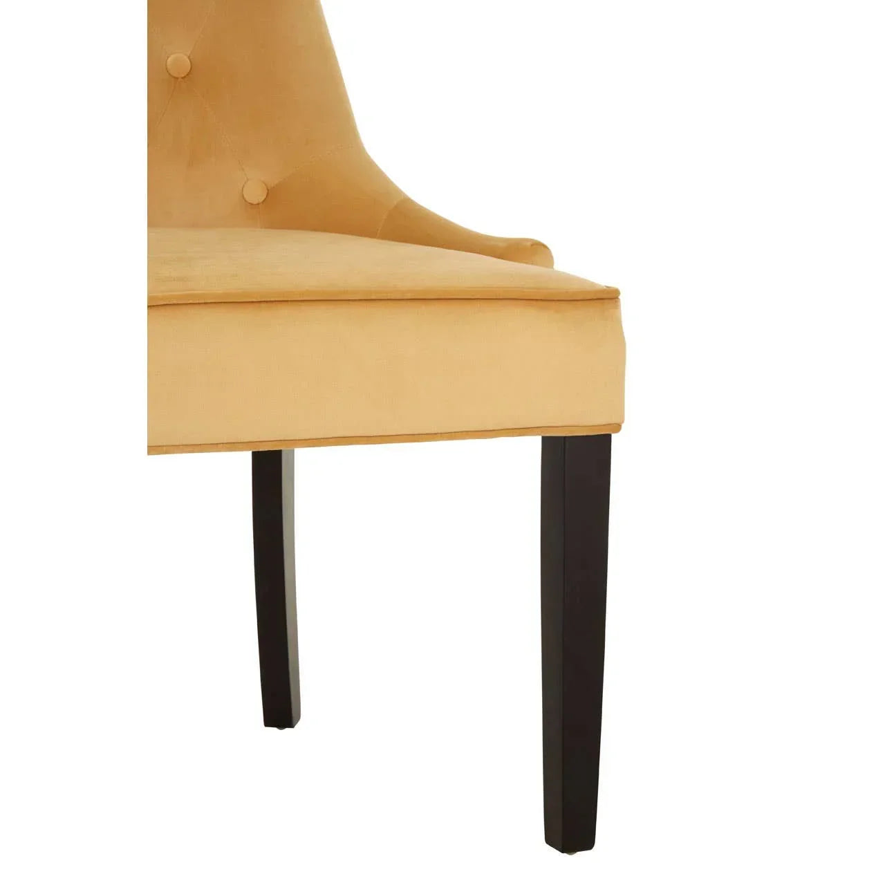 Upholstered dining chair with mustard velvet seat and dark wooden legs, side angle view