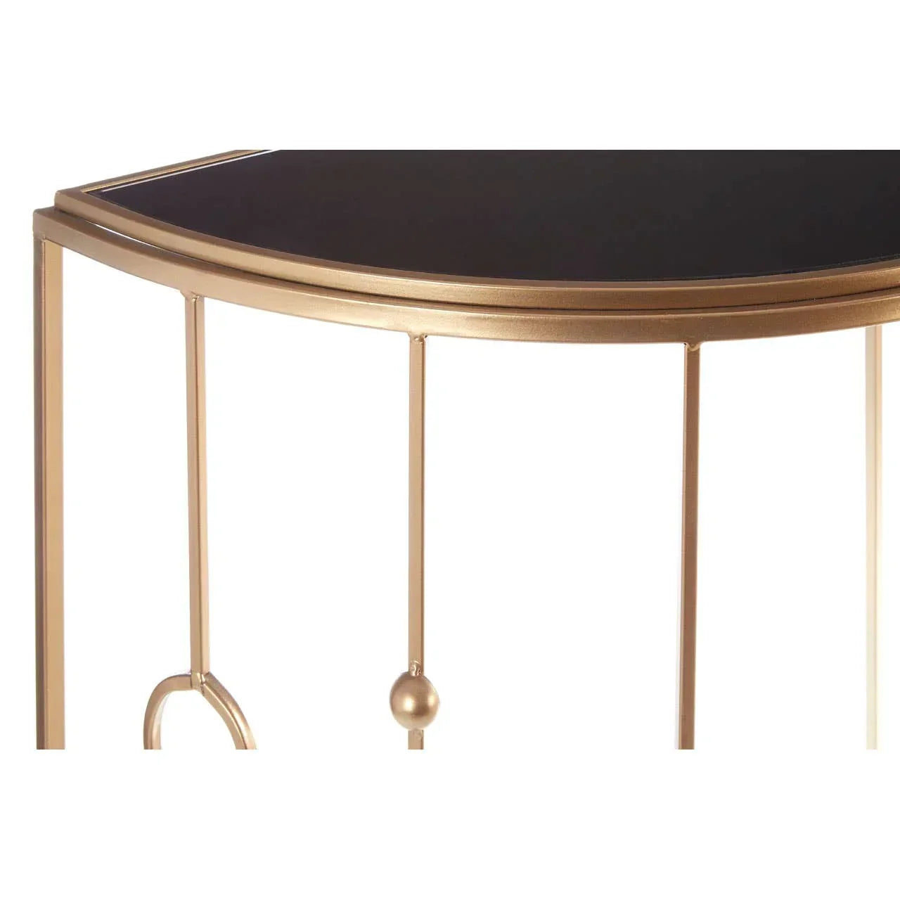Gold metal console table with black top and decorative frame detail, close up view