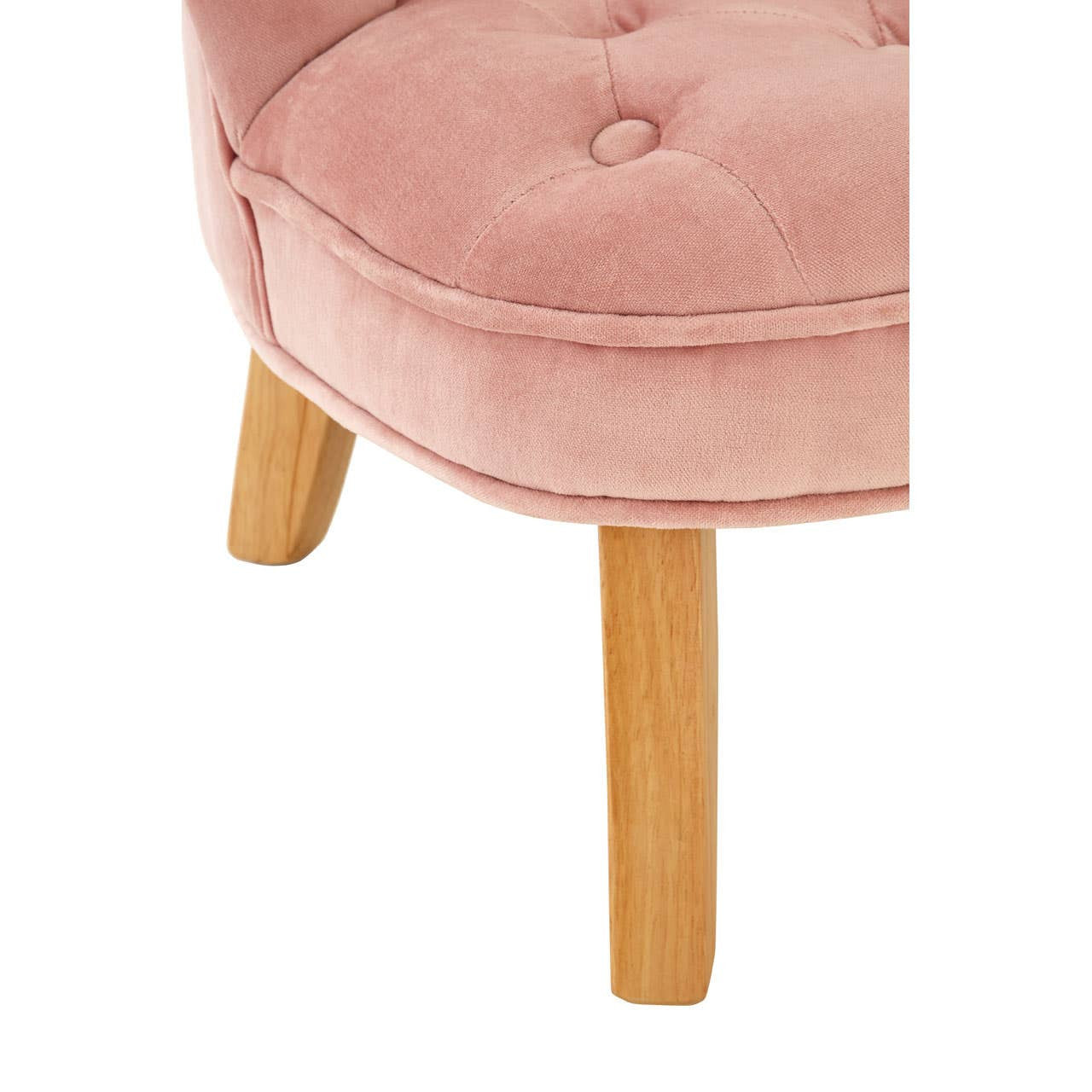 A close-up view of a pink velvet kids chair featuring a tufted seat and light wooden legs, showcasing its soft texture and playful design