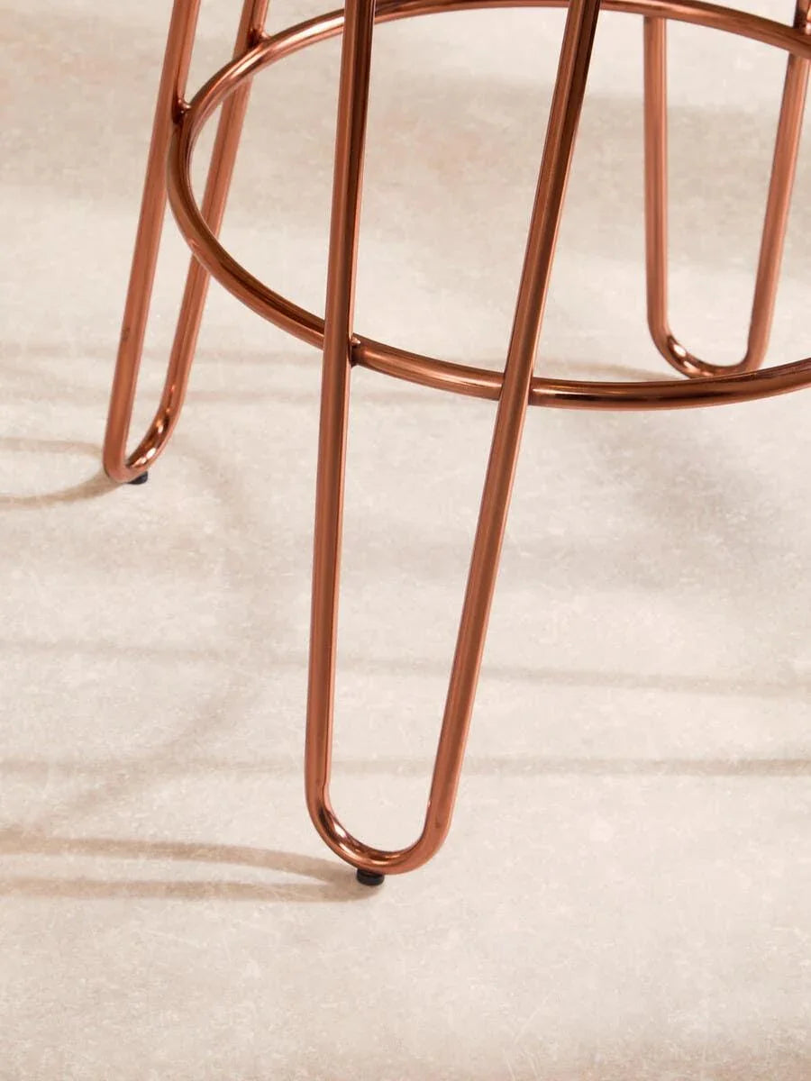 Copper metal stool legs with round footrest on light floor