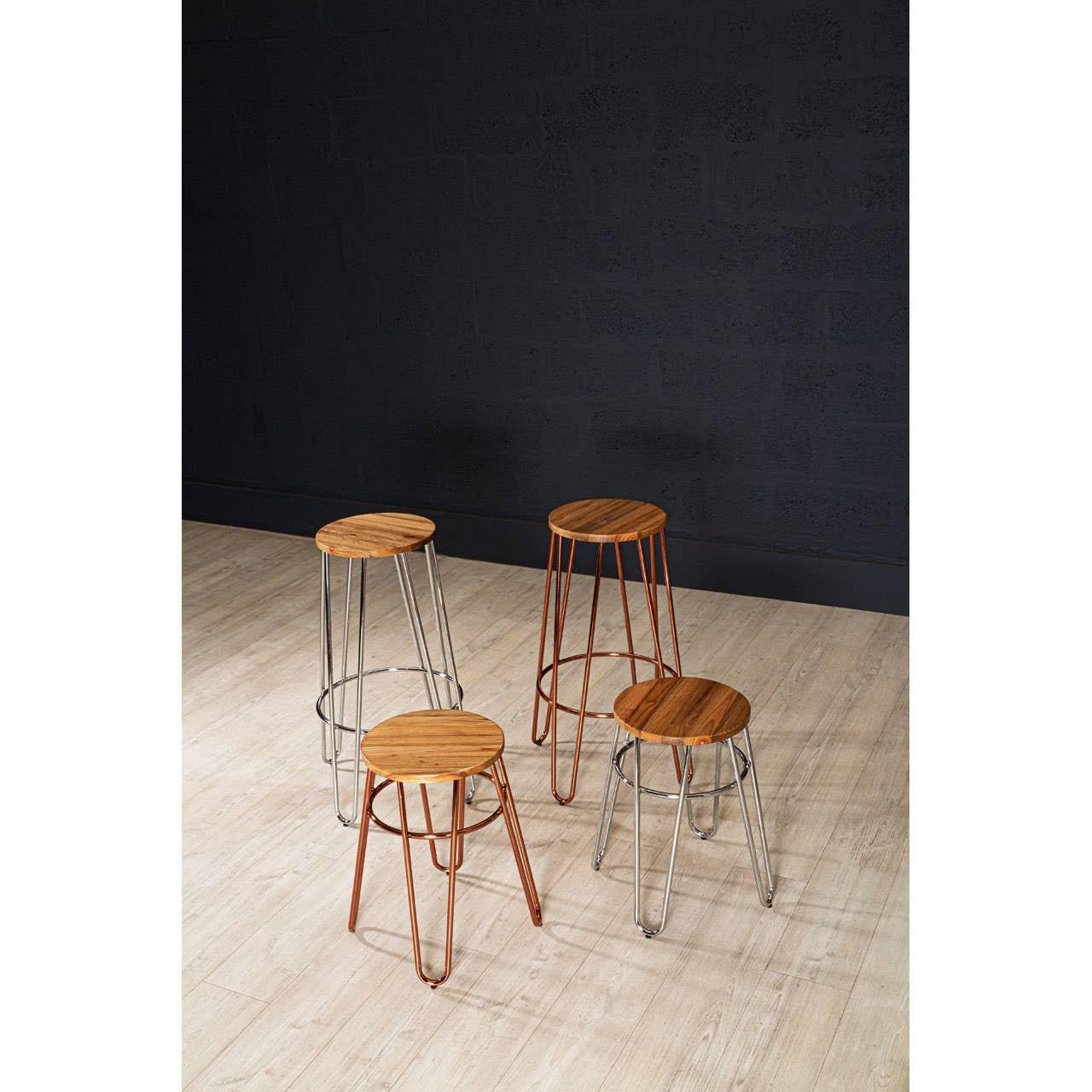 Set of four bar stools with round wooden seats and metal legs on light wood floor
