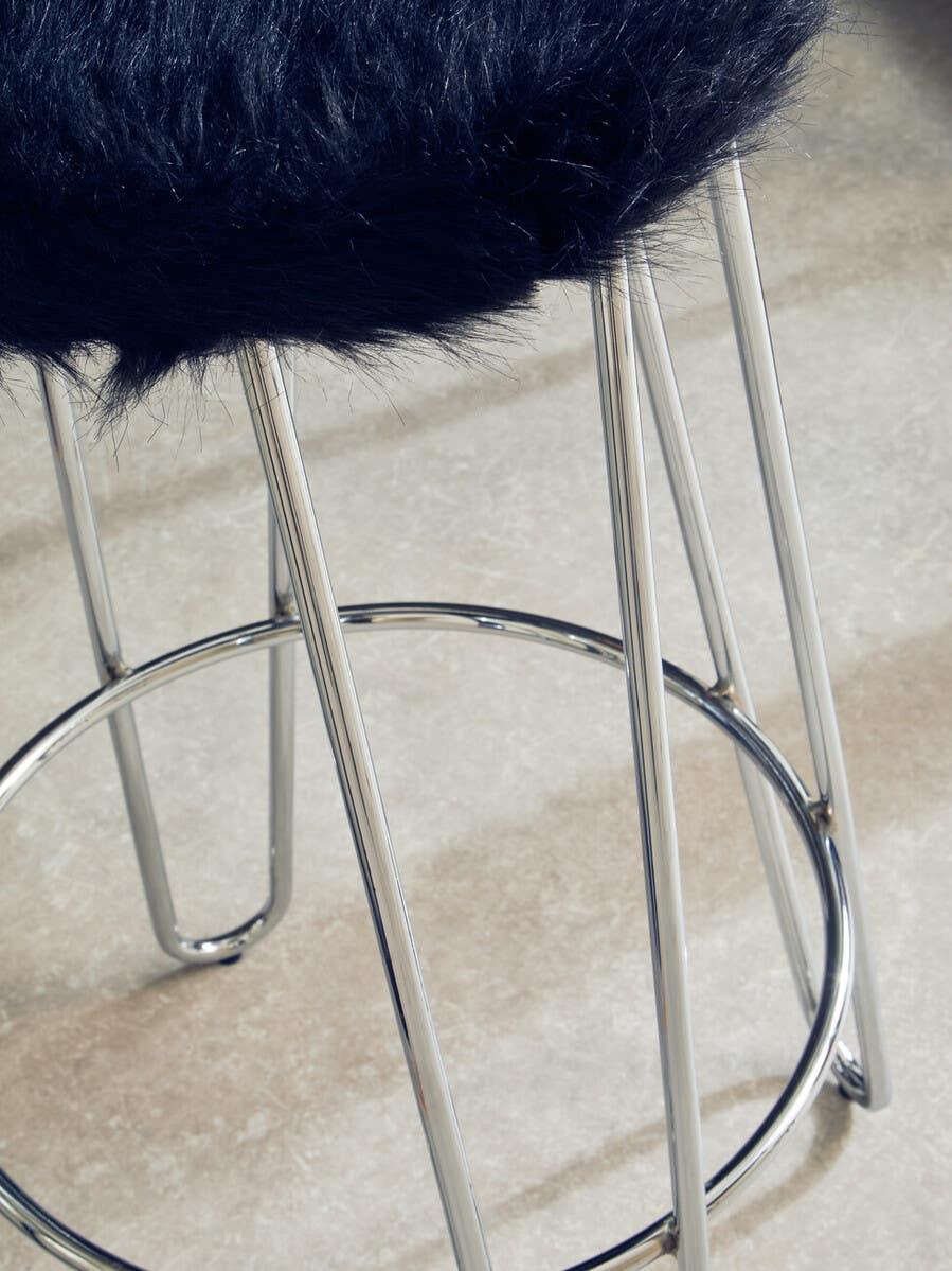 Bar stool with black faux fur seat and chrome metal legs on tiled floor