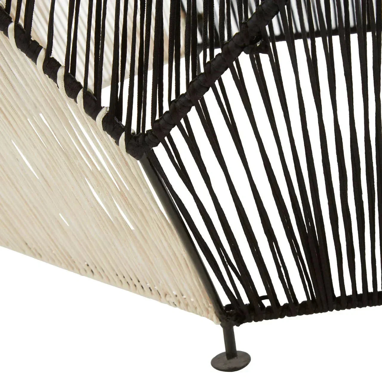 Closeup of black and white woven string furniture detail with metal leg