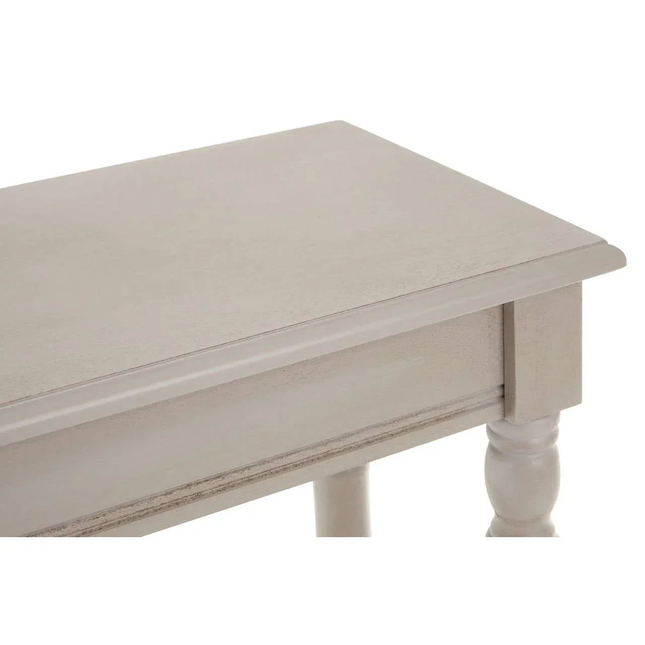 Close-up of wooden table corner with turned leg and light painted finish