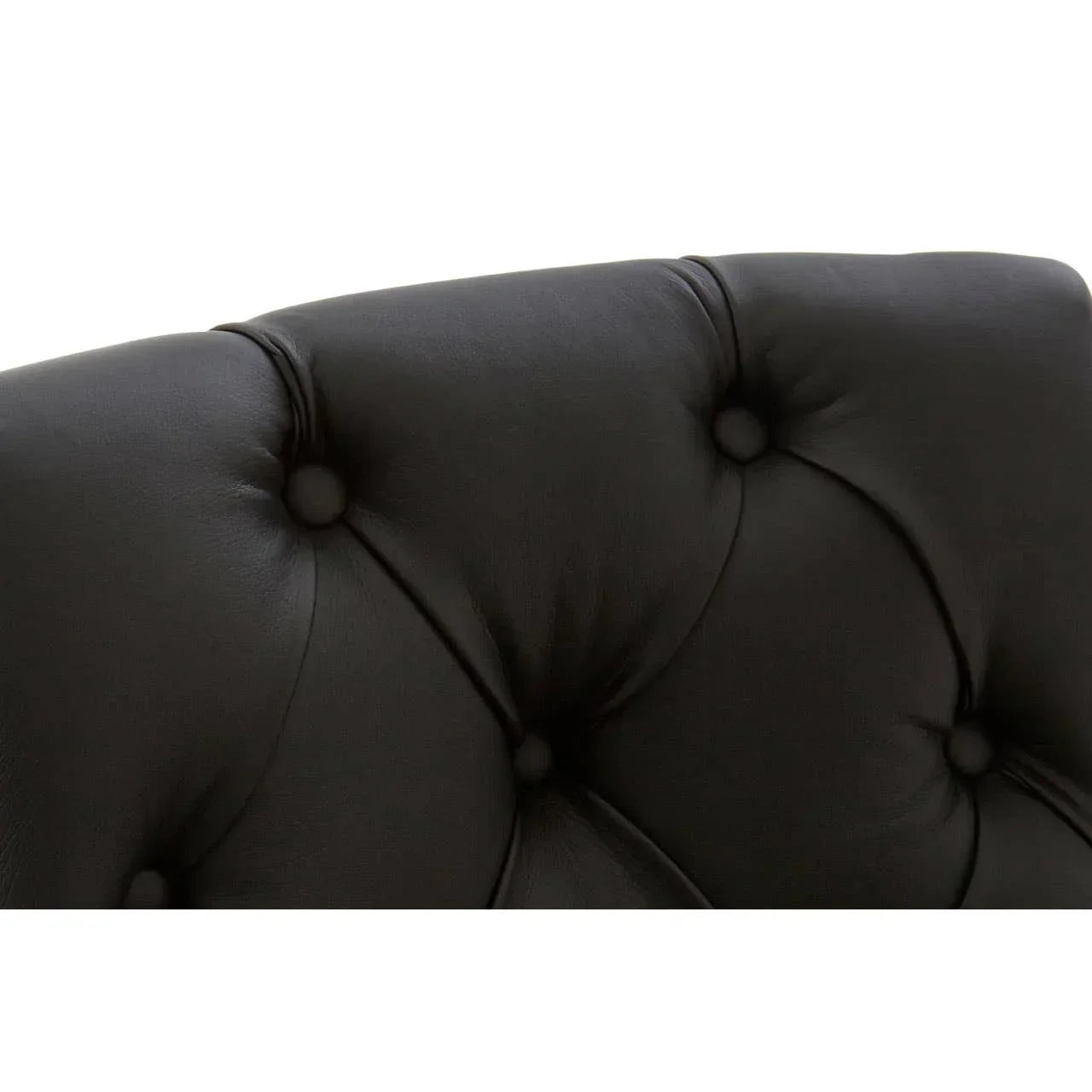 Close up of black leather tufted sofa backrest with button detail