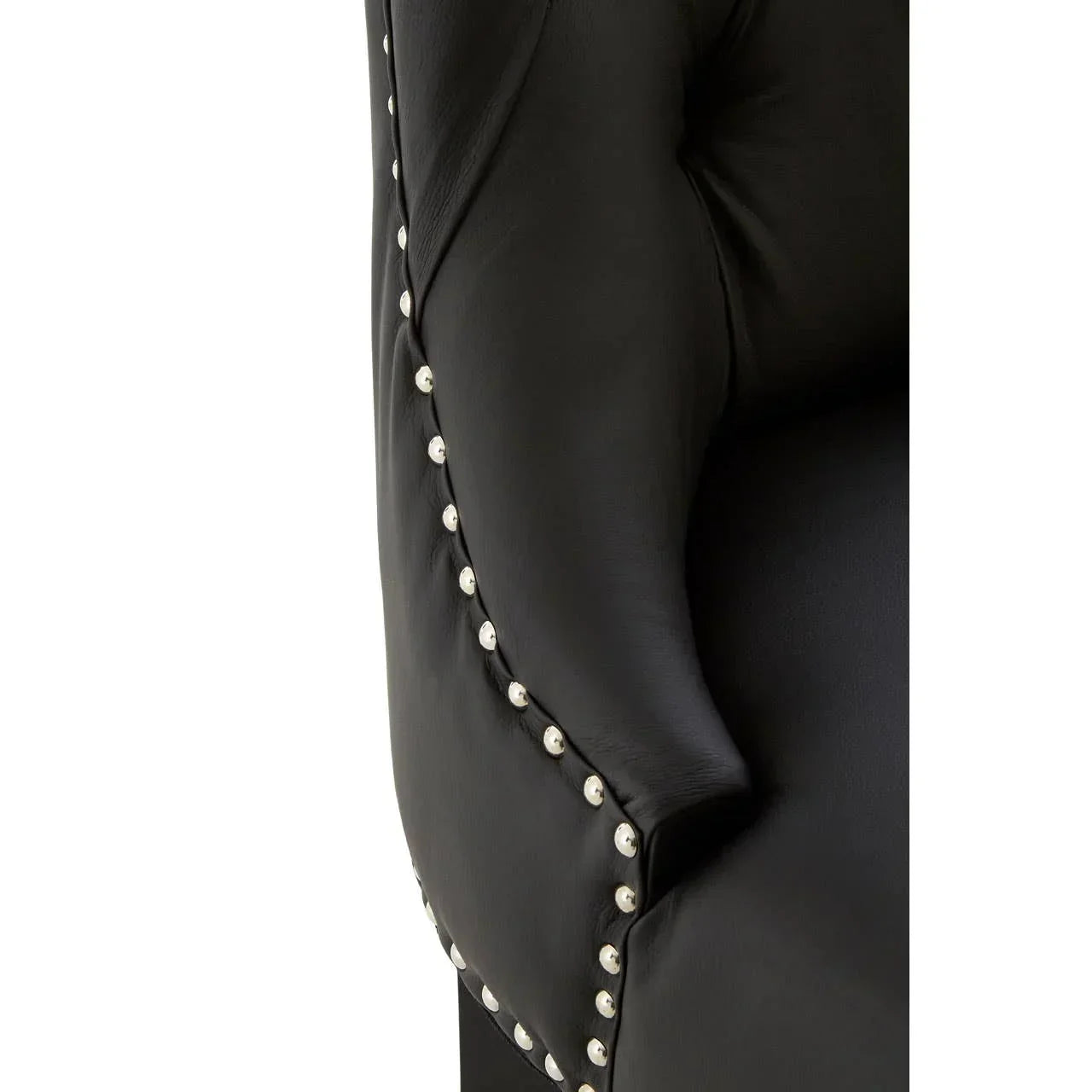 Close detail of black leather accent chair with silver stud trim and tufted upholstery