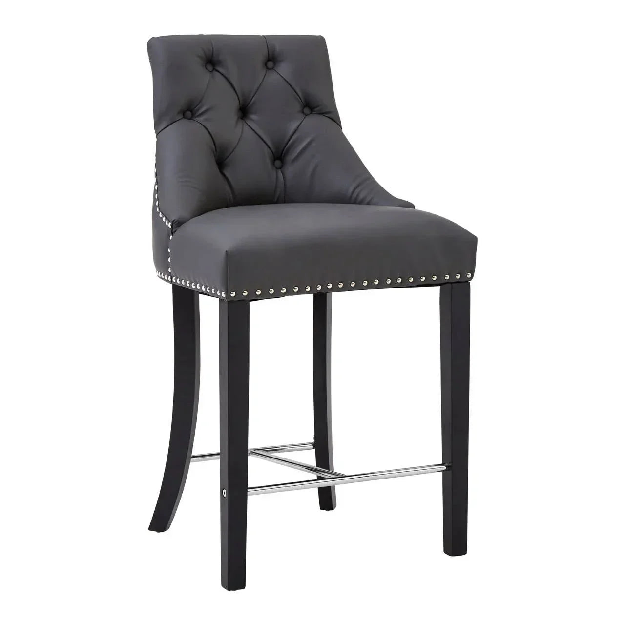 Black leather bar stool with button-tufted back, studded trim, and metal footrest