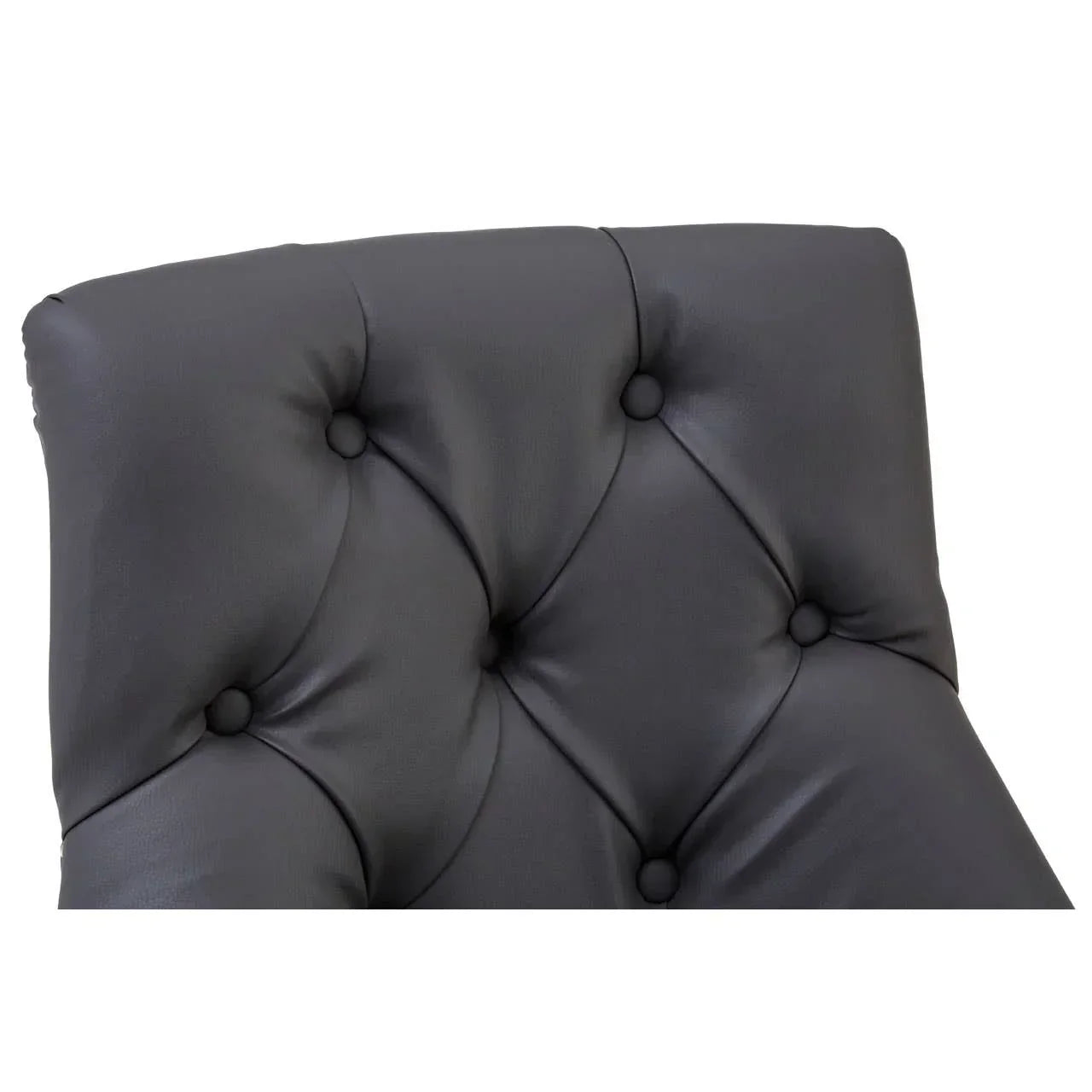 Close-up of black leather tufted chair backrest with button detailing