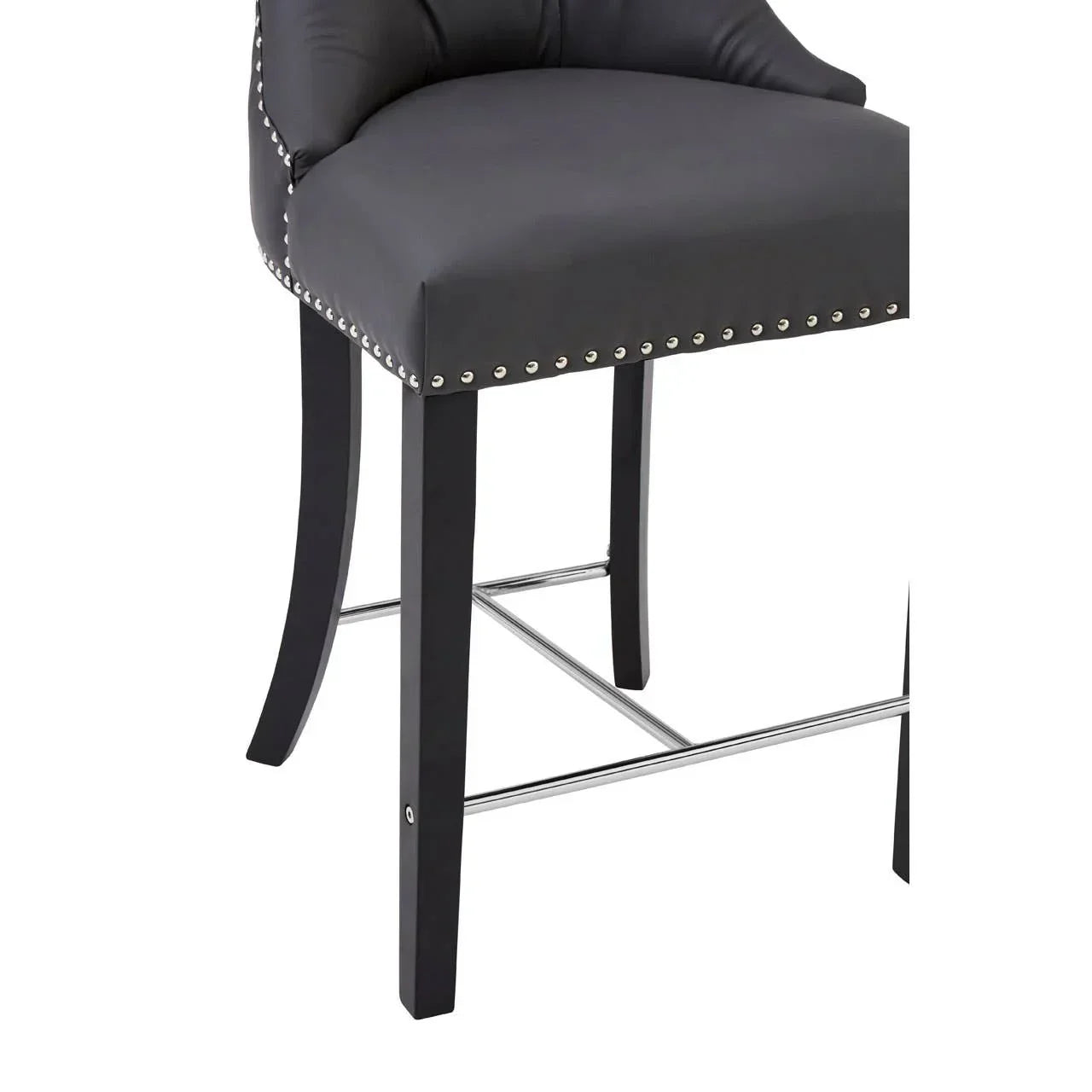 Black bar stool with studded trim, padded seat and metal footrest, front angle view