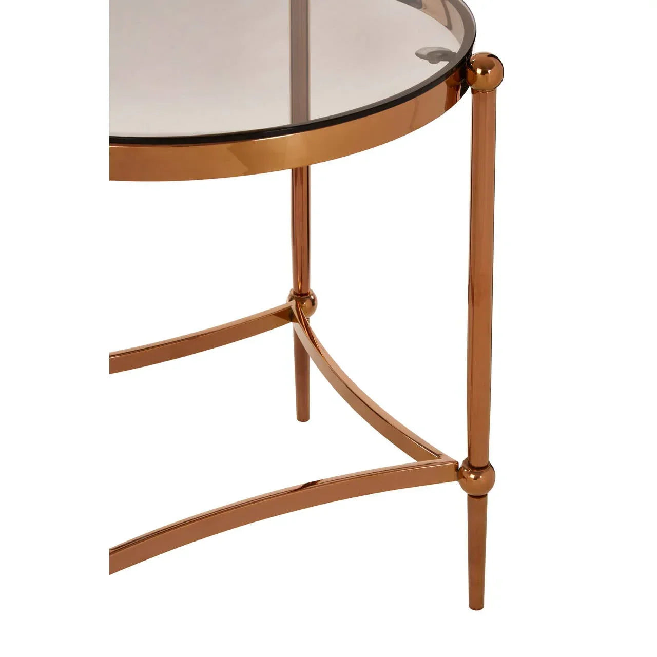 Round glass side table with gold metal frame, showing close-up of legs and edge