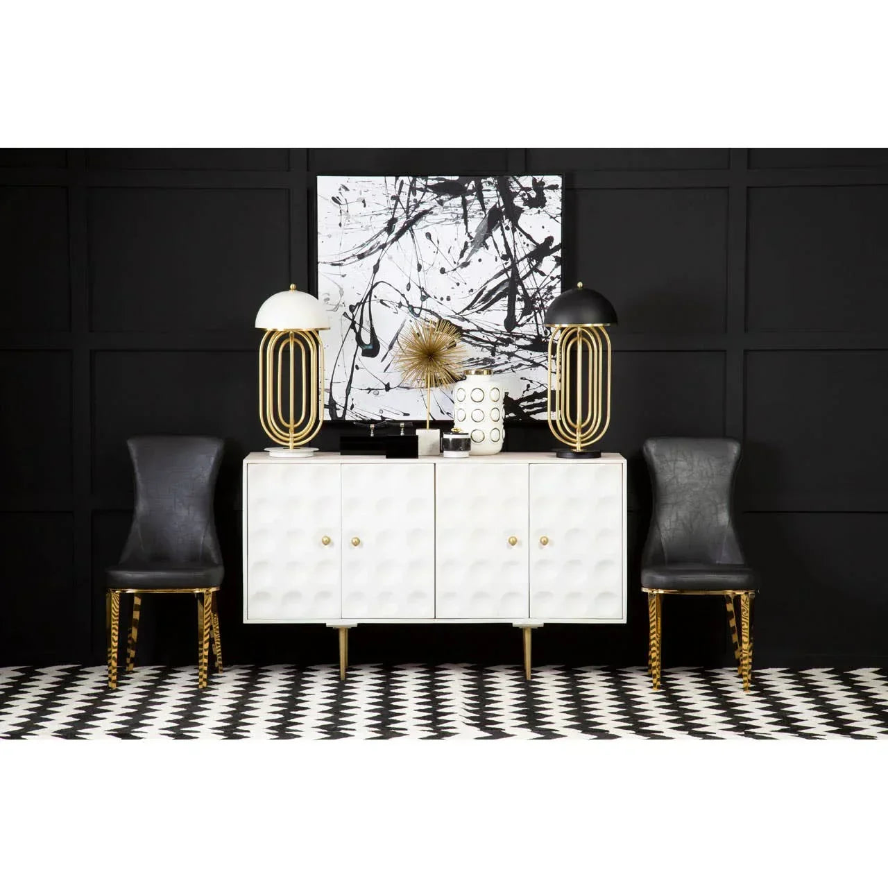 White sideboard with gold handles, black chairs, abstract art and lamps in modern living room