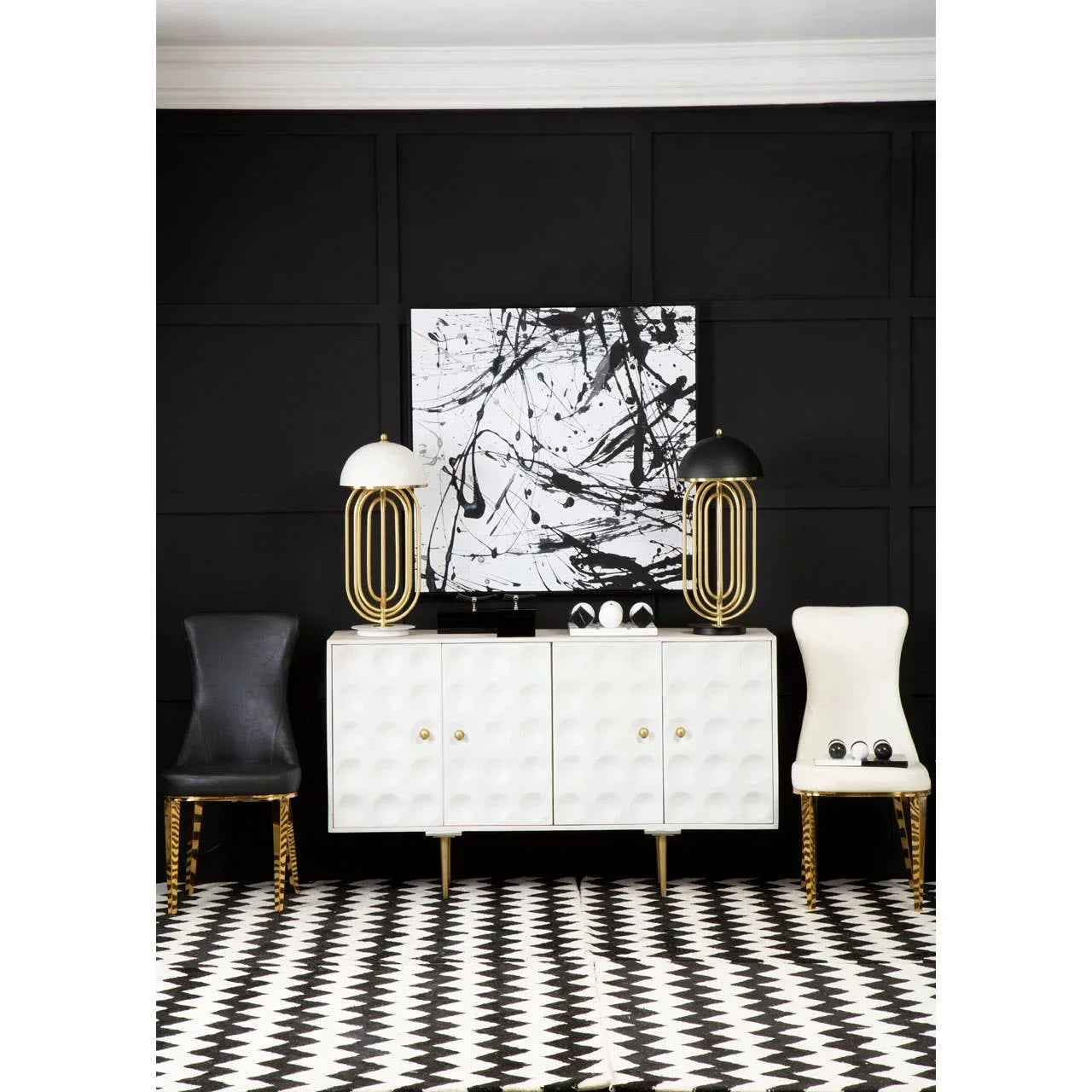 White textured sideboard with gold accents, black and white decor, modern chairs, patterned rug