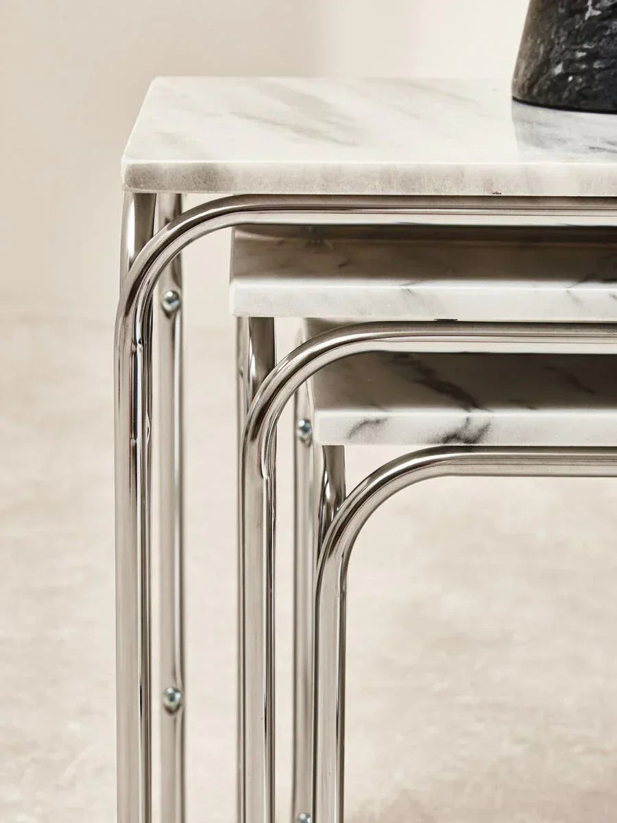 Set of marble effect nesting tables with chrome legs, side view