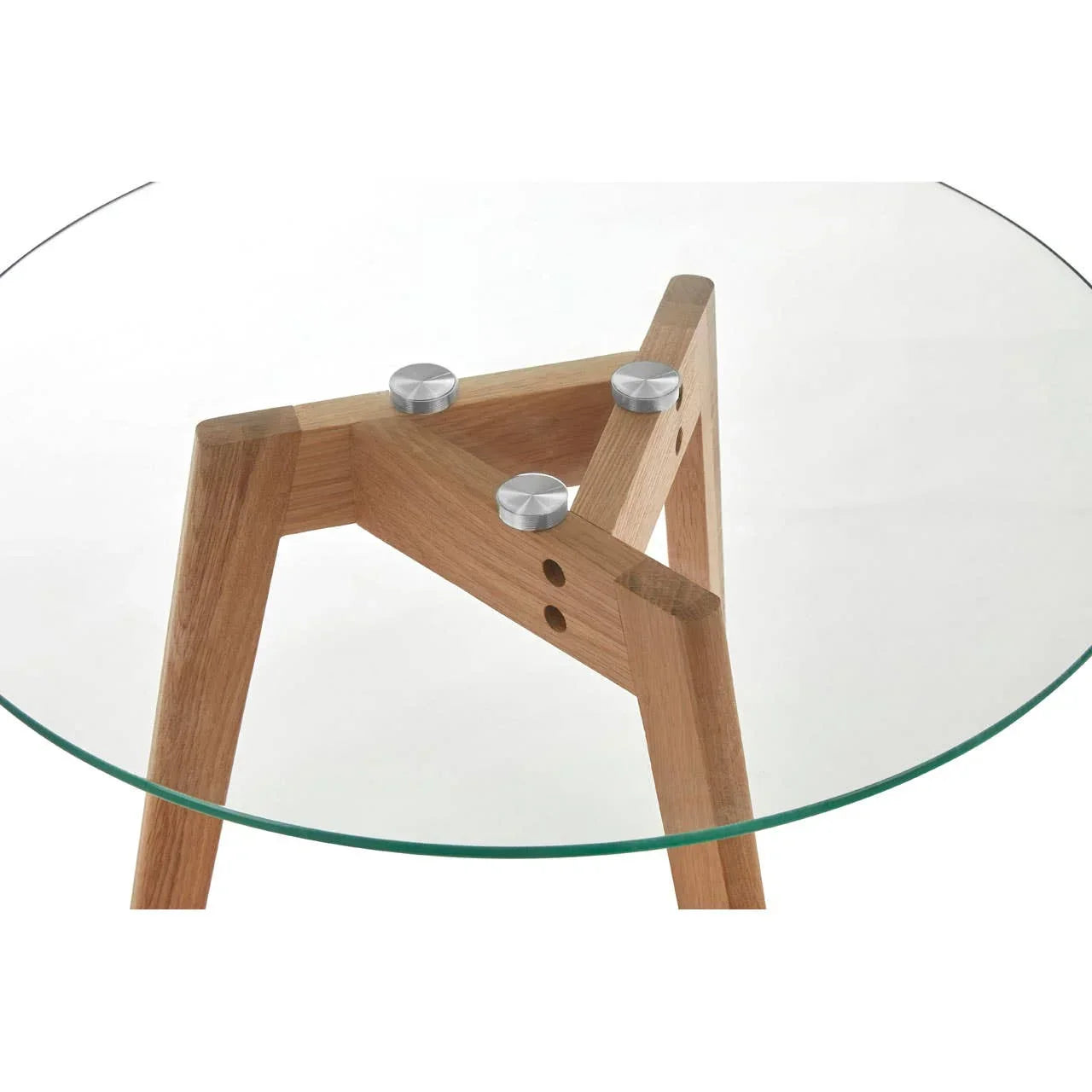 Glass dining table with round top and wooden legs, close-up of metal fixings