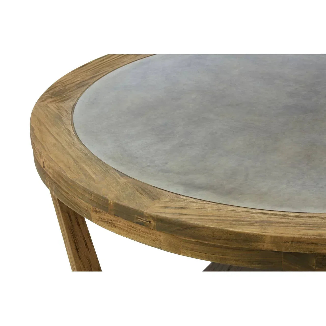 Closeup of round wooden dining table with smooth grey concrete top
