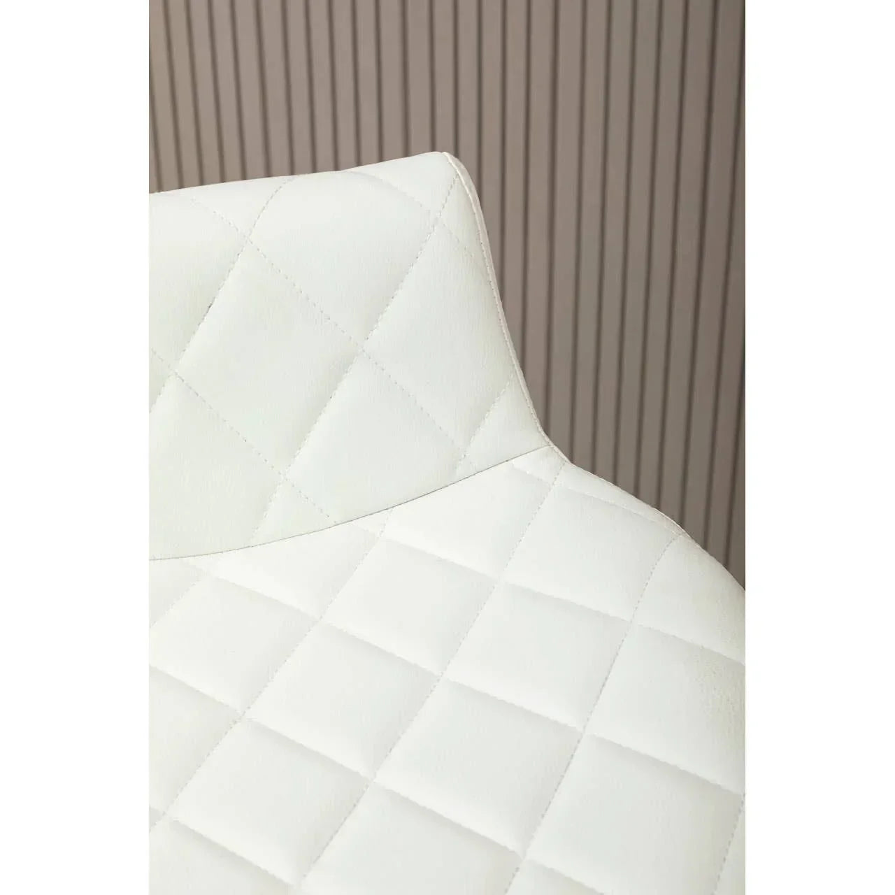 White faux leather dining chair with quilted stitching and modern backrest detail