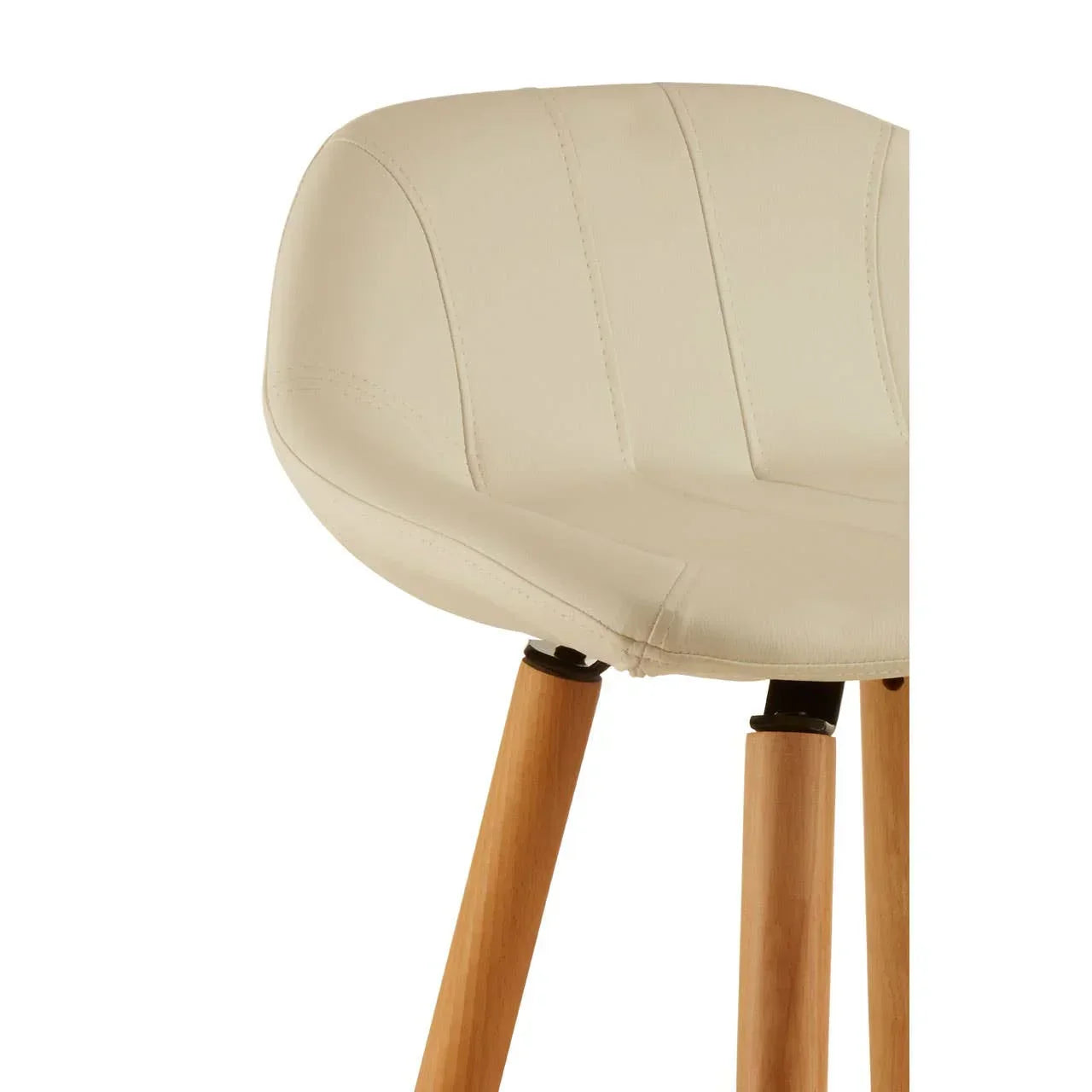 Close-up of cream upholstered dining chair with wooden legs