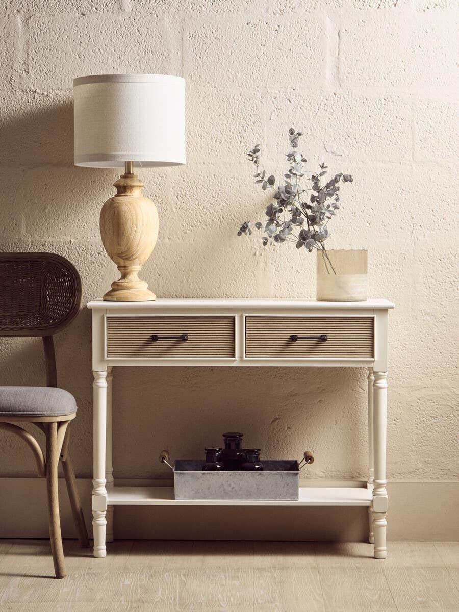 White console table with two drawers, styled with table lamp, chair and decorative vase