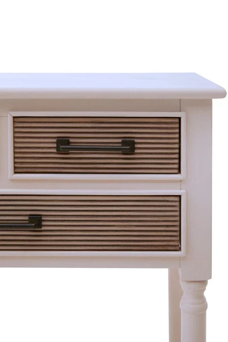 White wooden console table with two ribbed drawers and black handles, close-up view