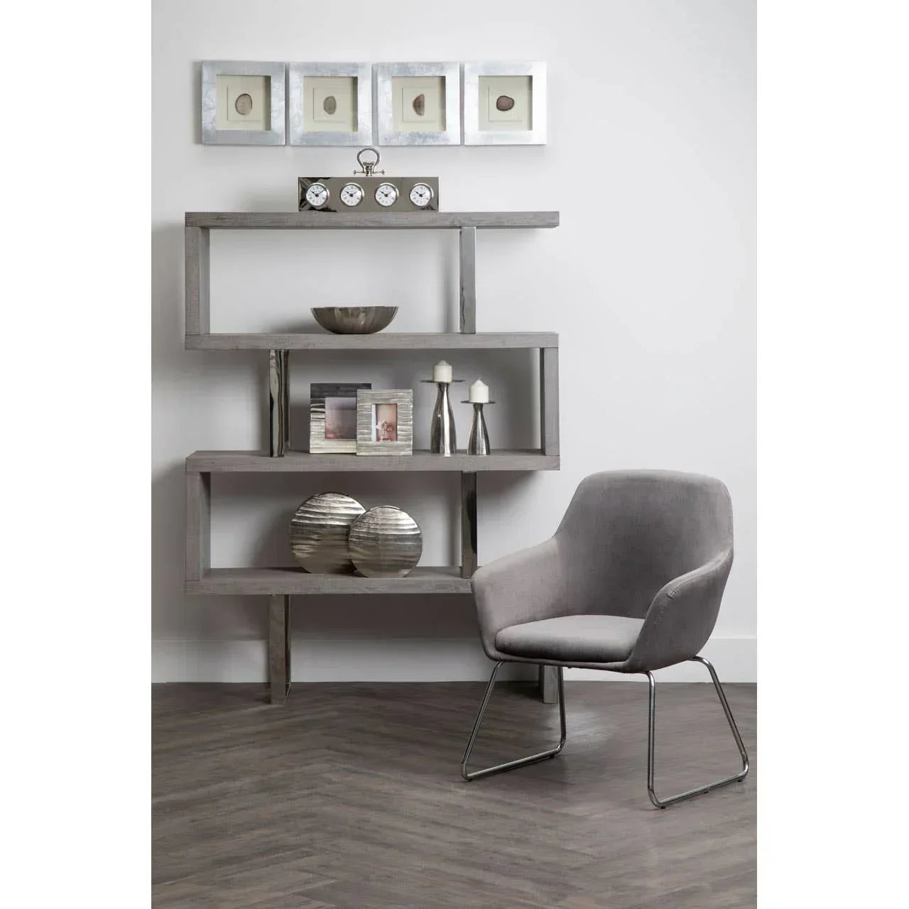 Modern grey armchair and abstract wood shelving unit with decor in contemporary living space
