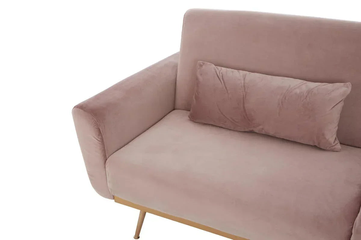 Blush pink velvet sofa with gold legs and matching lumbar cushion, corner angle view