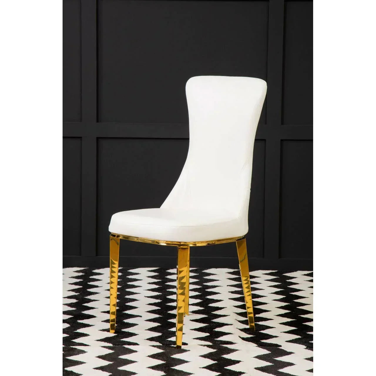 White dining chair with gold metal legs on black and white patterned floor
