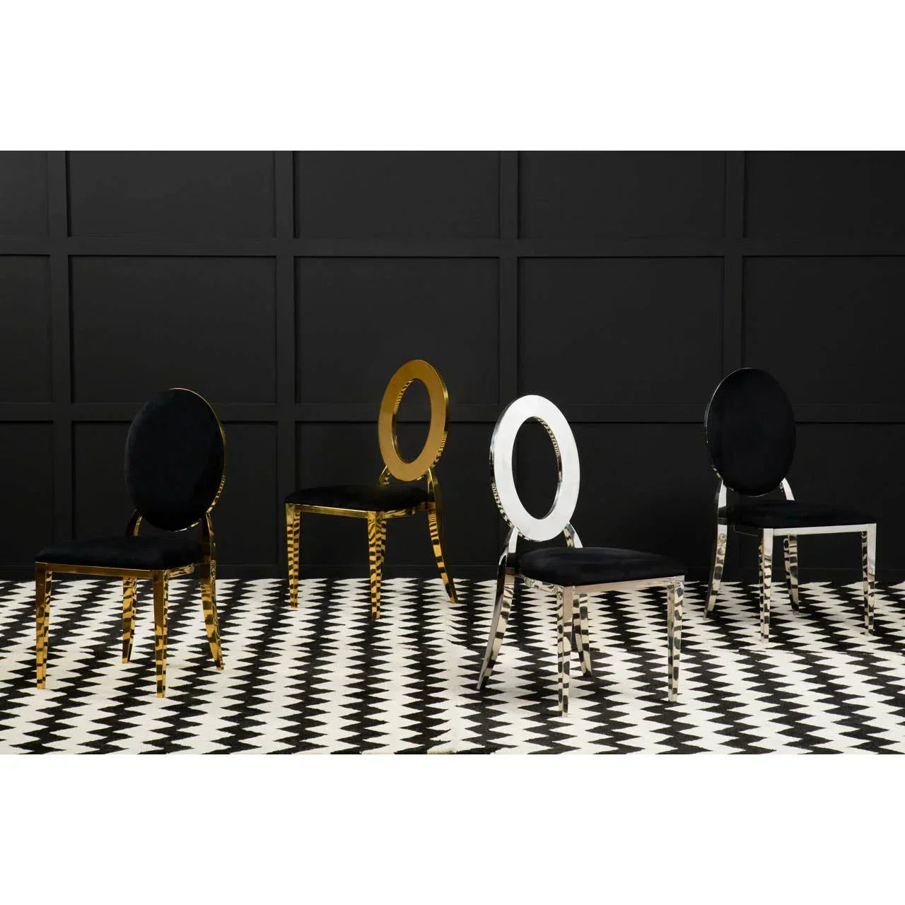 Modern dining chairs with black velvet seats, gold and chrome frames on geometric floor