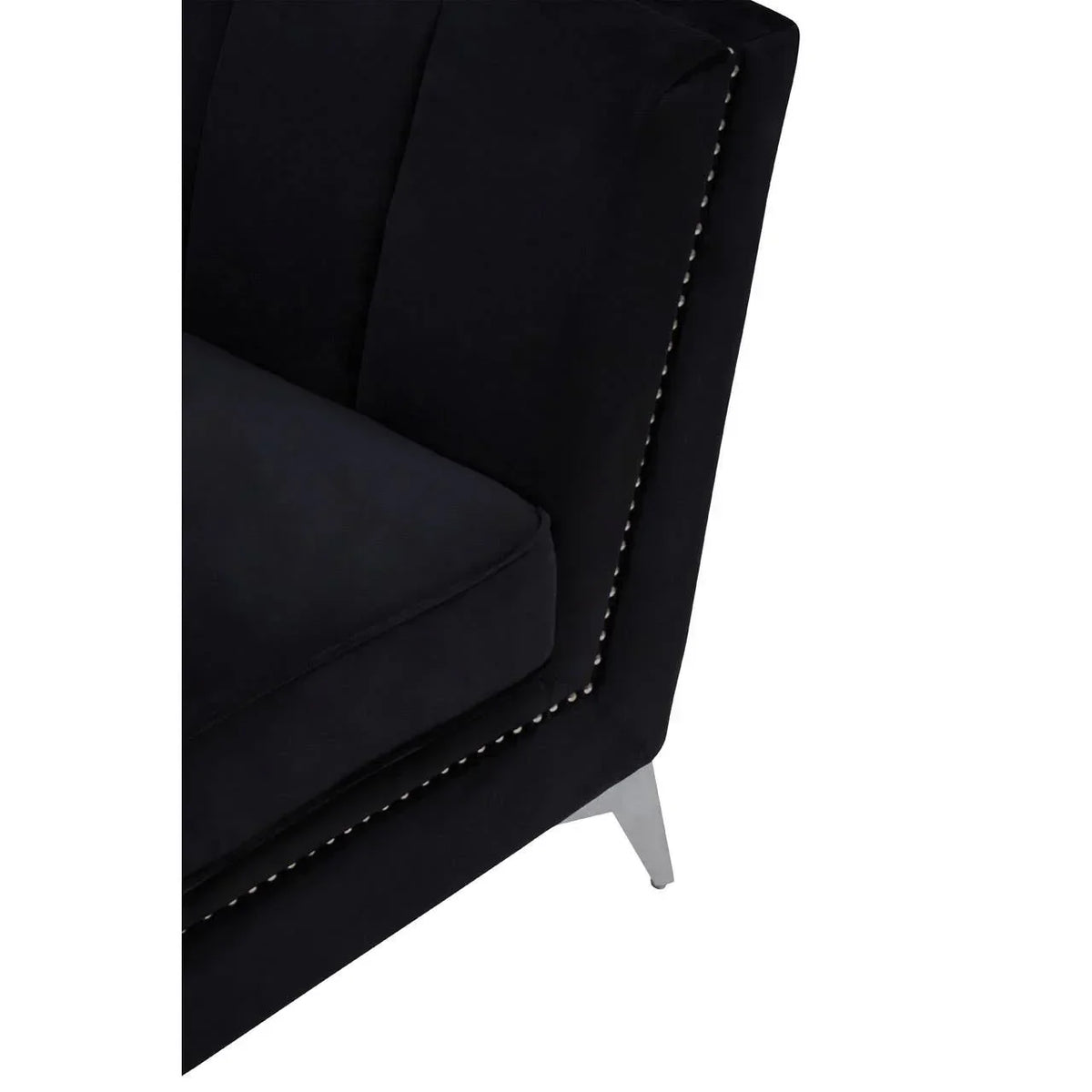 Black velvet sofa corner with metal leg and studded trim detail