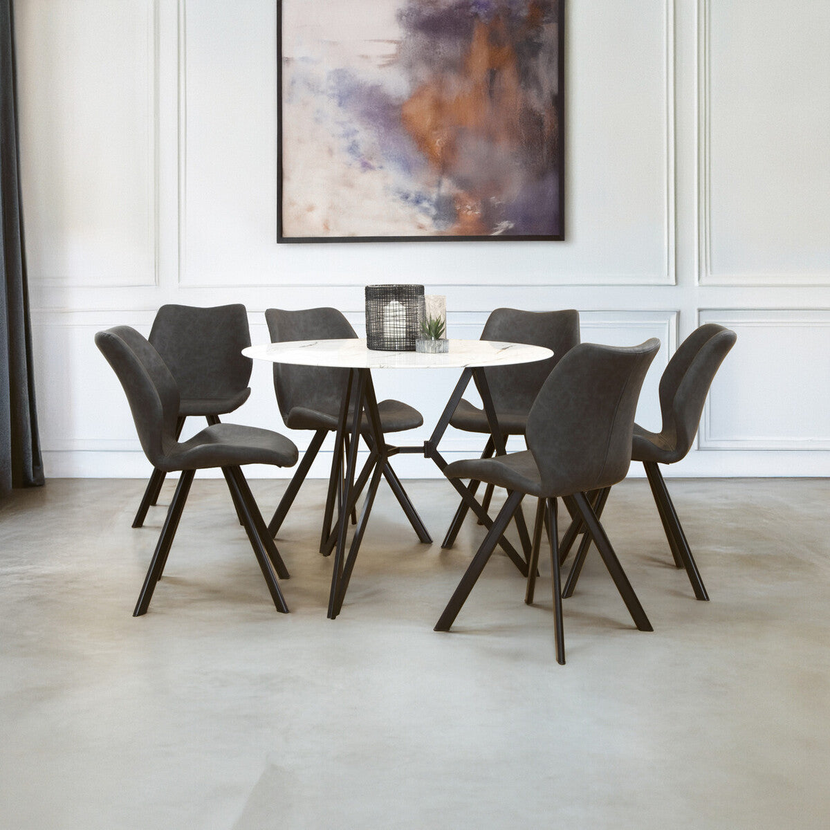 Round dining table with a marble effect top surrounded by six upholstered chairs with dark frames, set in a modern dining area featuring a neutral color palette and a large abstract artwork on the wall. The floor is light-colored, enhancing the contemporary aesthetic of the space