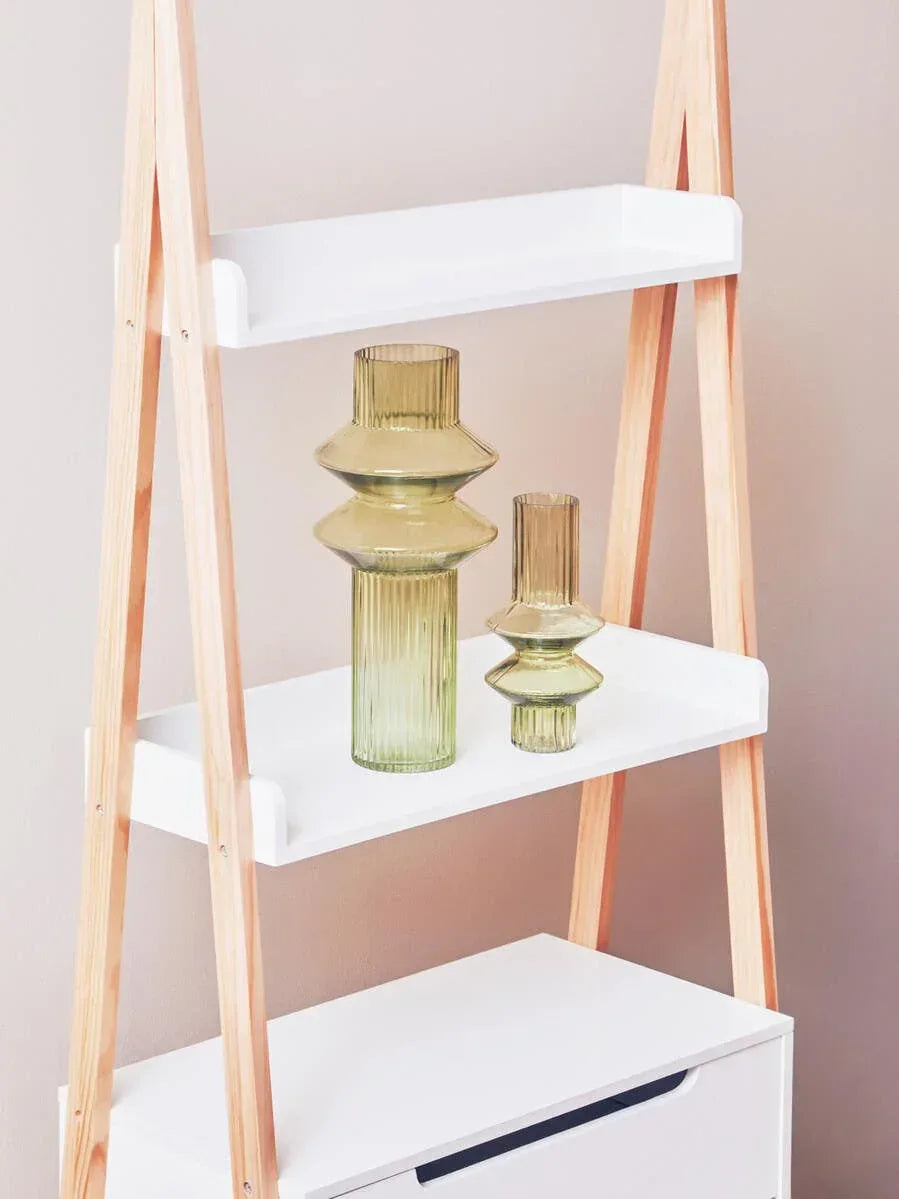 Wood and white ladder shelf with two ribbed glass vases displayed on middle shelf