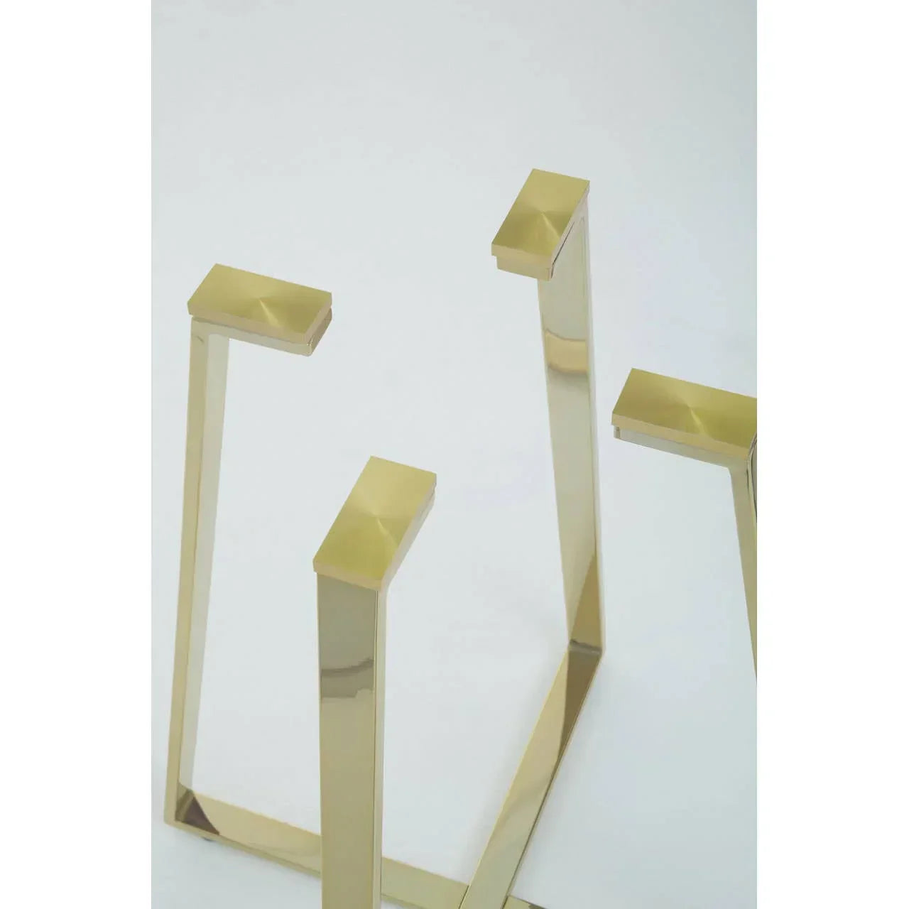 gold metal table legs with modern geometric design on white background