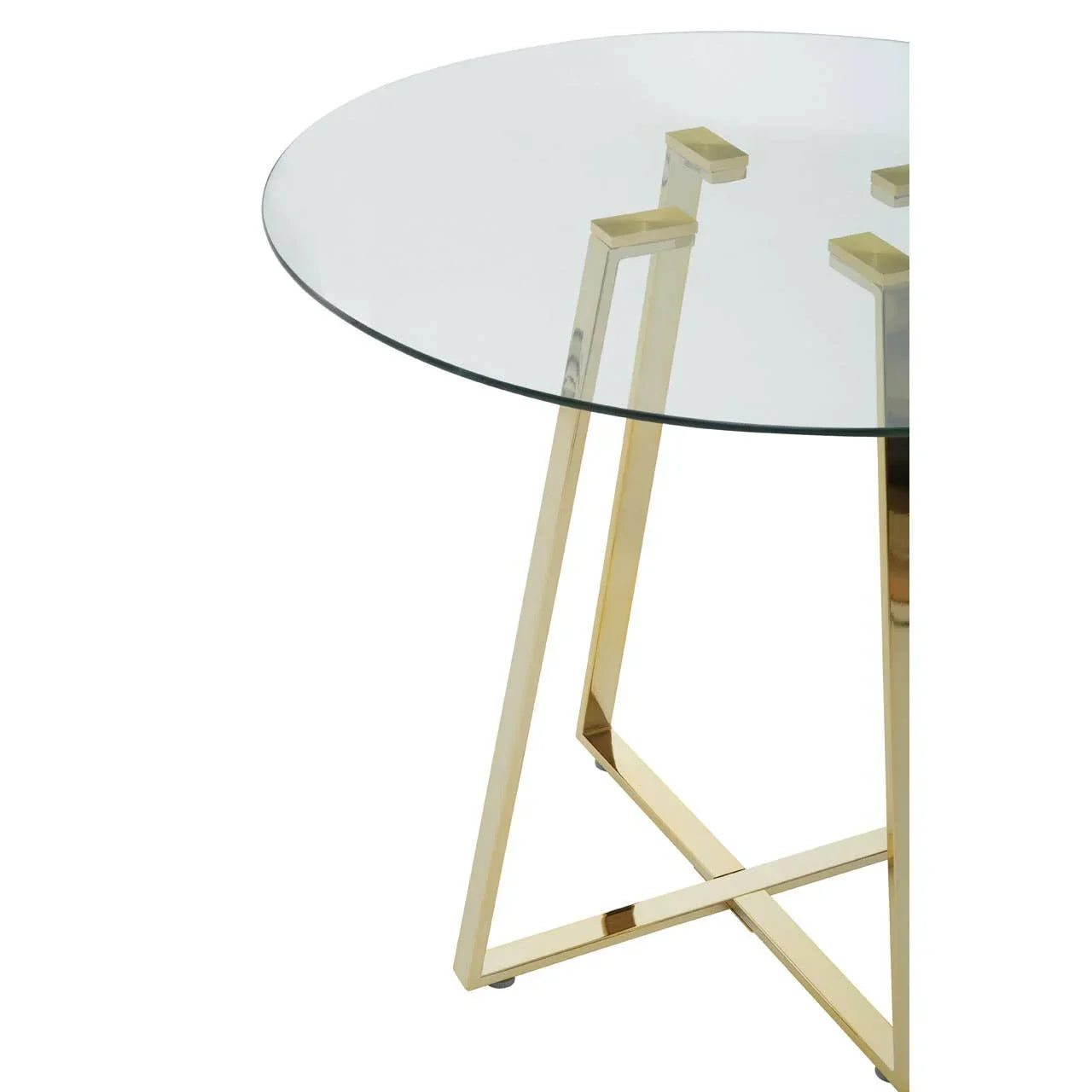 Round glass dining table with gold metal legs, close-up on modern base design