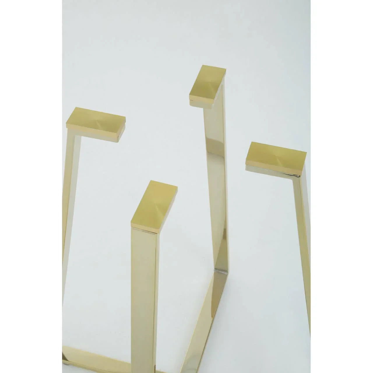 Gold metal table legs with a modern geometric design on white background