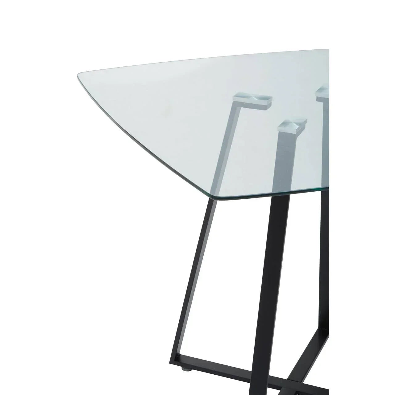 Glass dining table with black metal legs and triangular top, close-up of corner