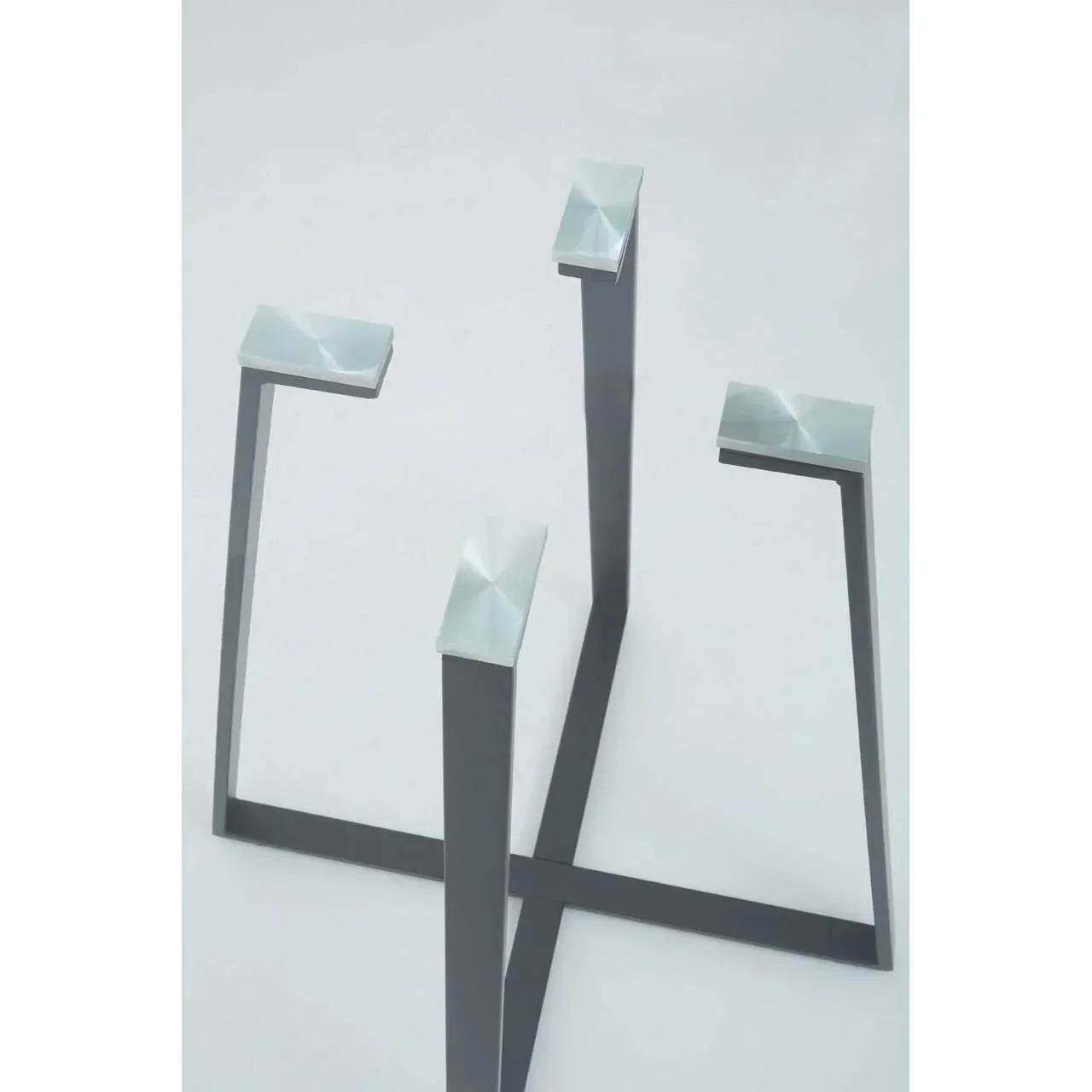 Black metal dining table base with four angled legs and brushed steel top plates
