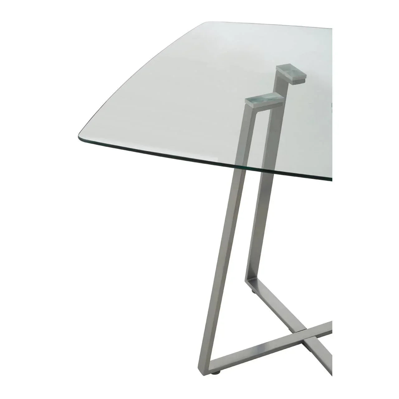 Glass dining table with square top and modern stainless steel legs, close-up corner view