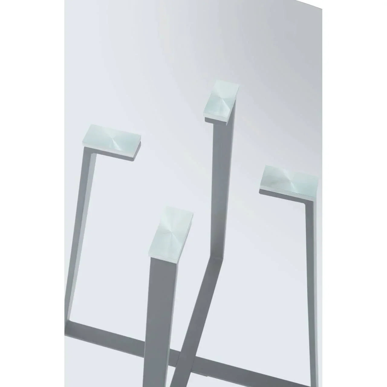 Brushed metal square dining table legs with cross frame, close up view