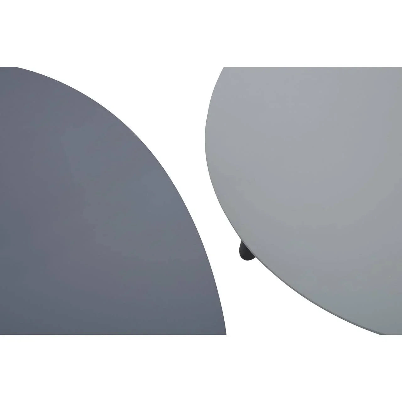Minimalist round nesting coffee tables with light grey and dark grey tops, close-up view