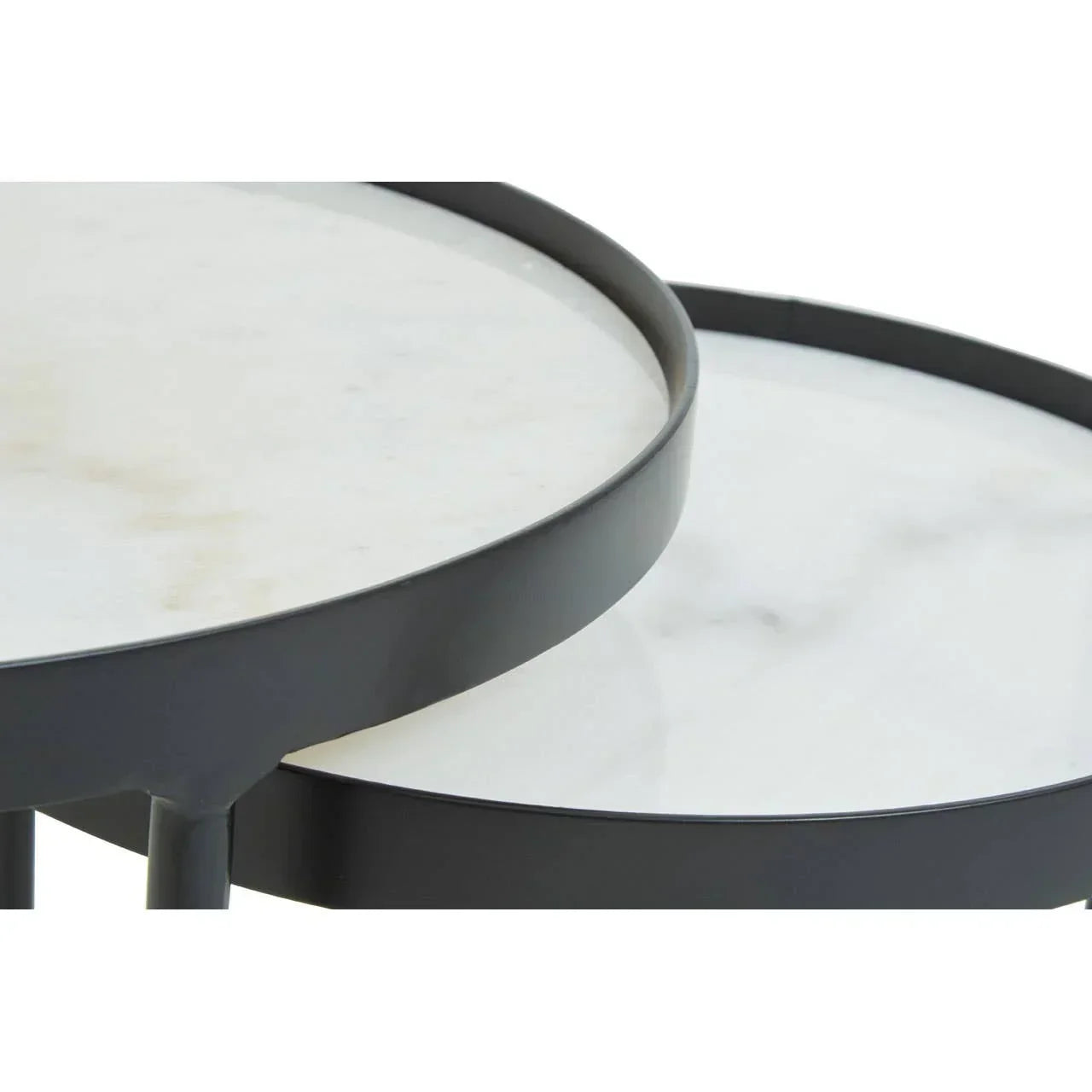 Closeup of white marble nesting coffee table tops with black metal frames
