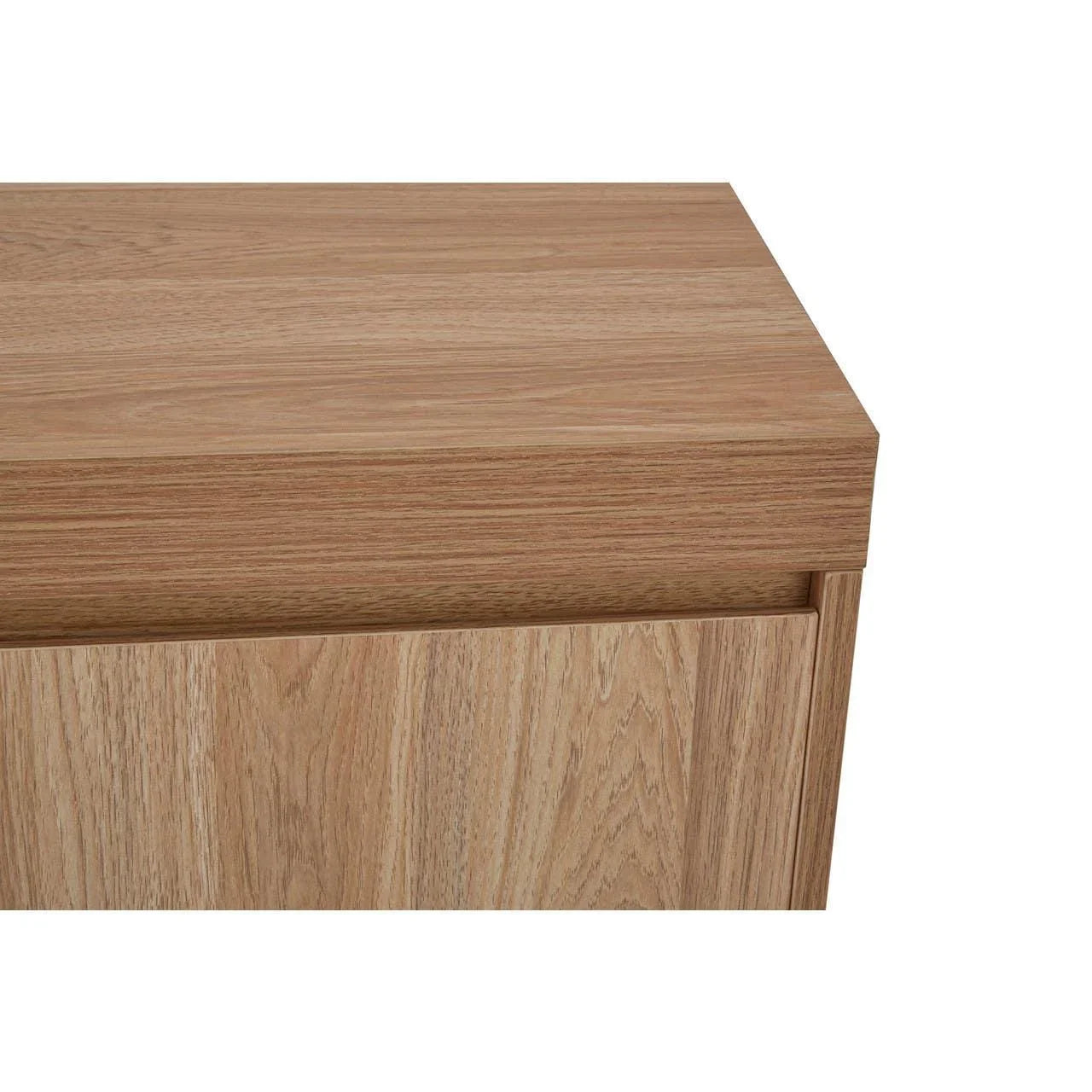 Close-up of light oak wood cabinet corner with clean lines and smooth surface