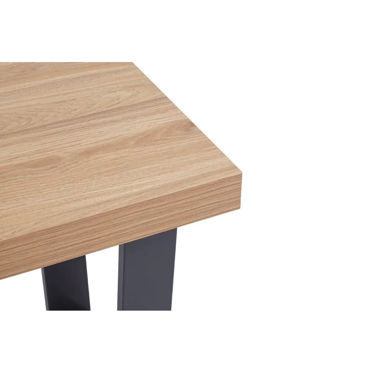Close-up of a wooden dining table corner with black metal legs