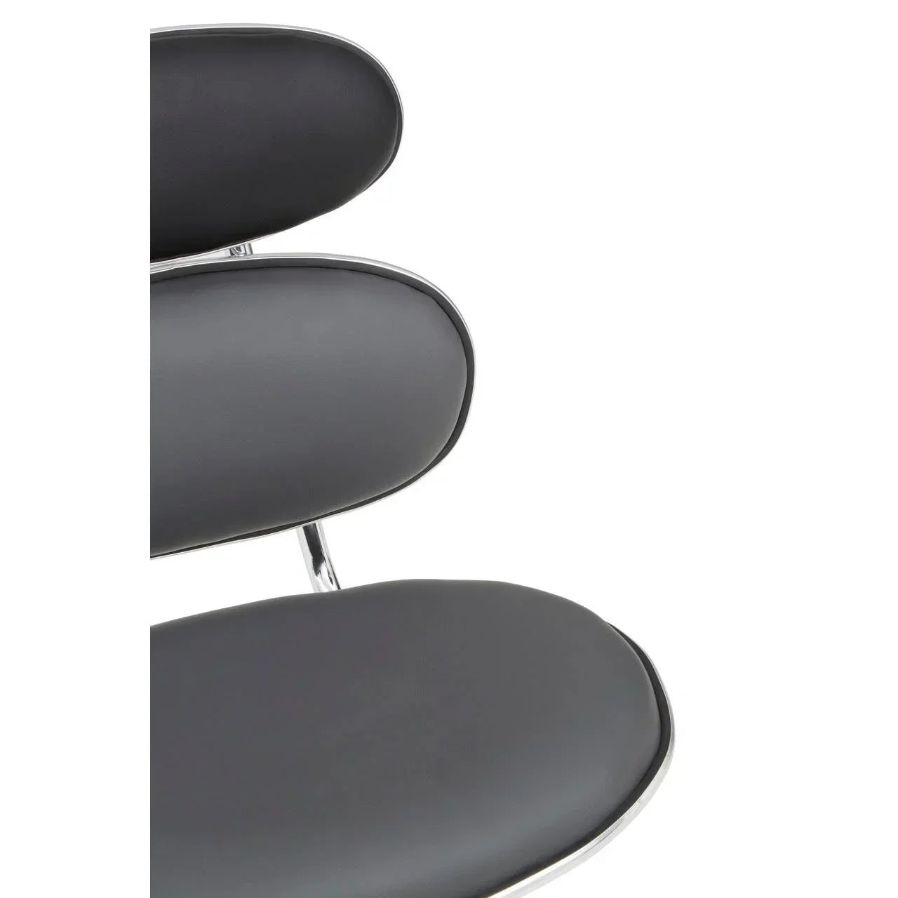 Closeup of black faux leather dining chair seat and backrest with chrome frame