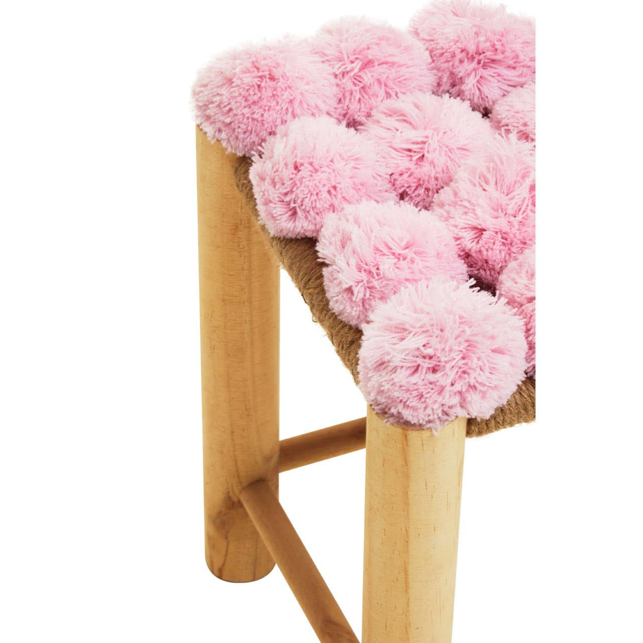 A wooden stool featuring a top adorned with fluffy pink pom poms, creating a playful and vibrant look. The legs are light-colored wood, providing a natural contrast to the soft pink accents