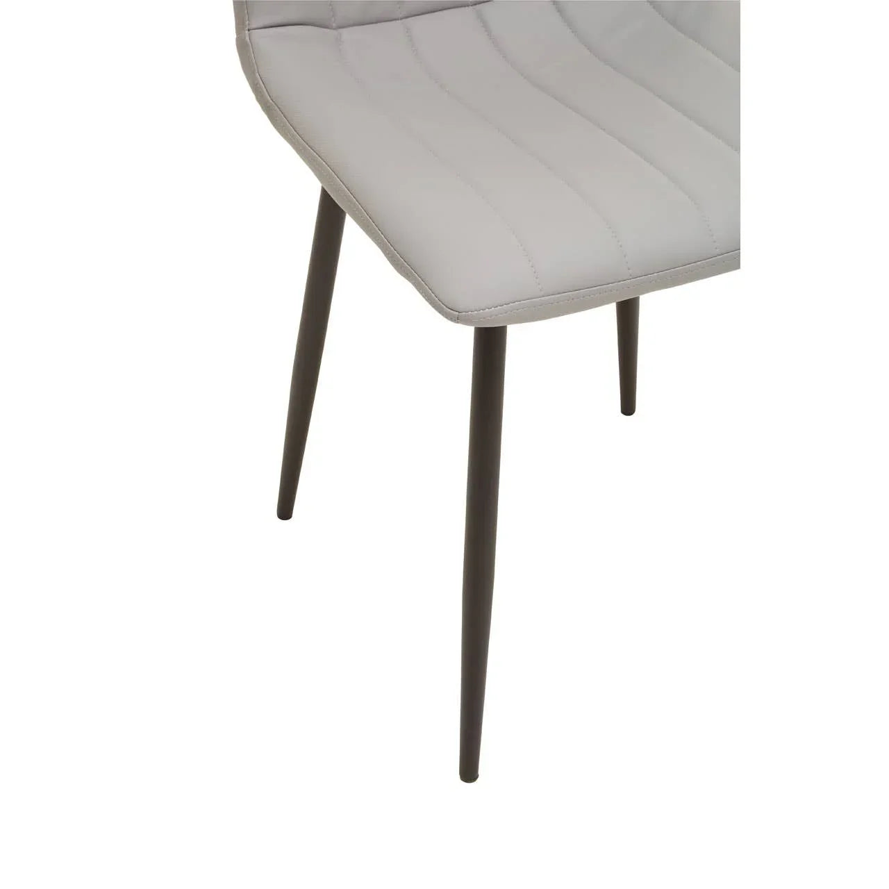 Close view of grey dining chair with stitched upholstery and black tapered metal legs