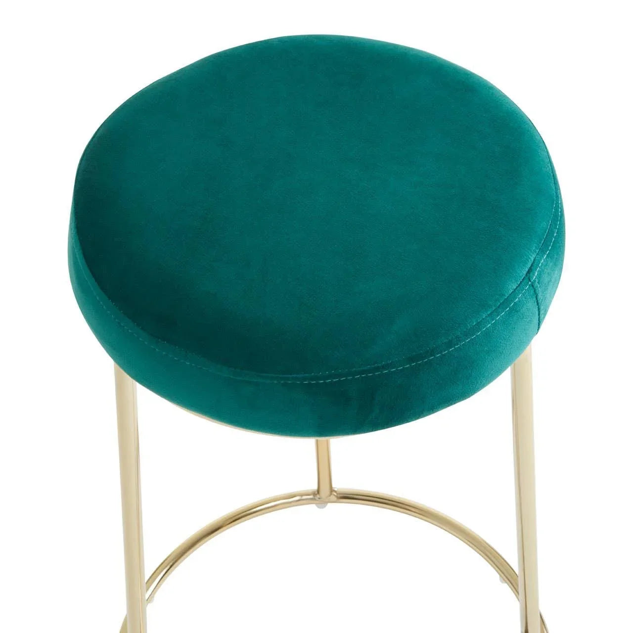 Green velvet round stool with gold metal legs, close-up top angle view